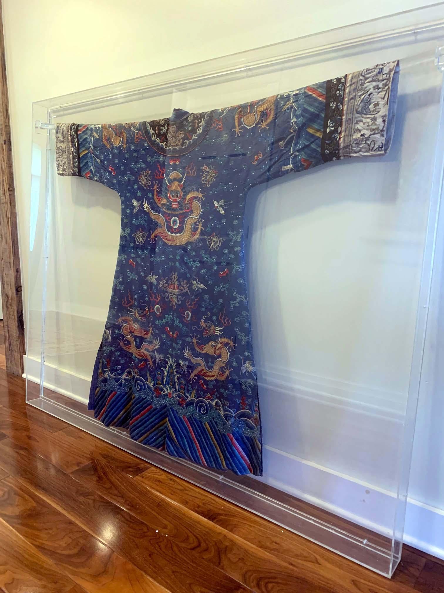 A blue silk embroidered dragon robe known in Chinese as Jifu (Auspicious Dress) circa mid-late 19th century from the Imperial Qing dynasty of China. The robe is elaborately embroidered with gold, silver and color threads with allover designs. Eight