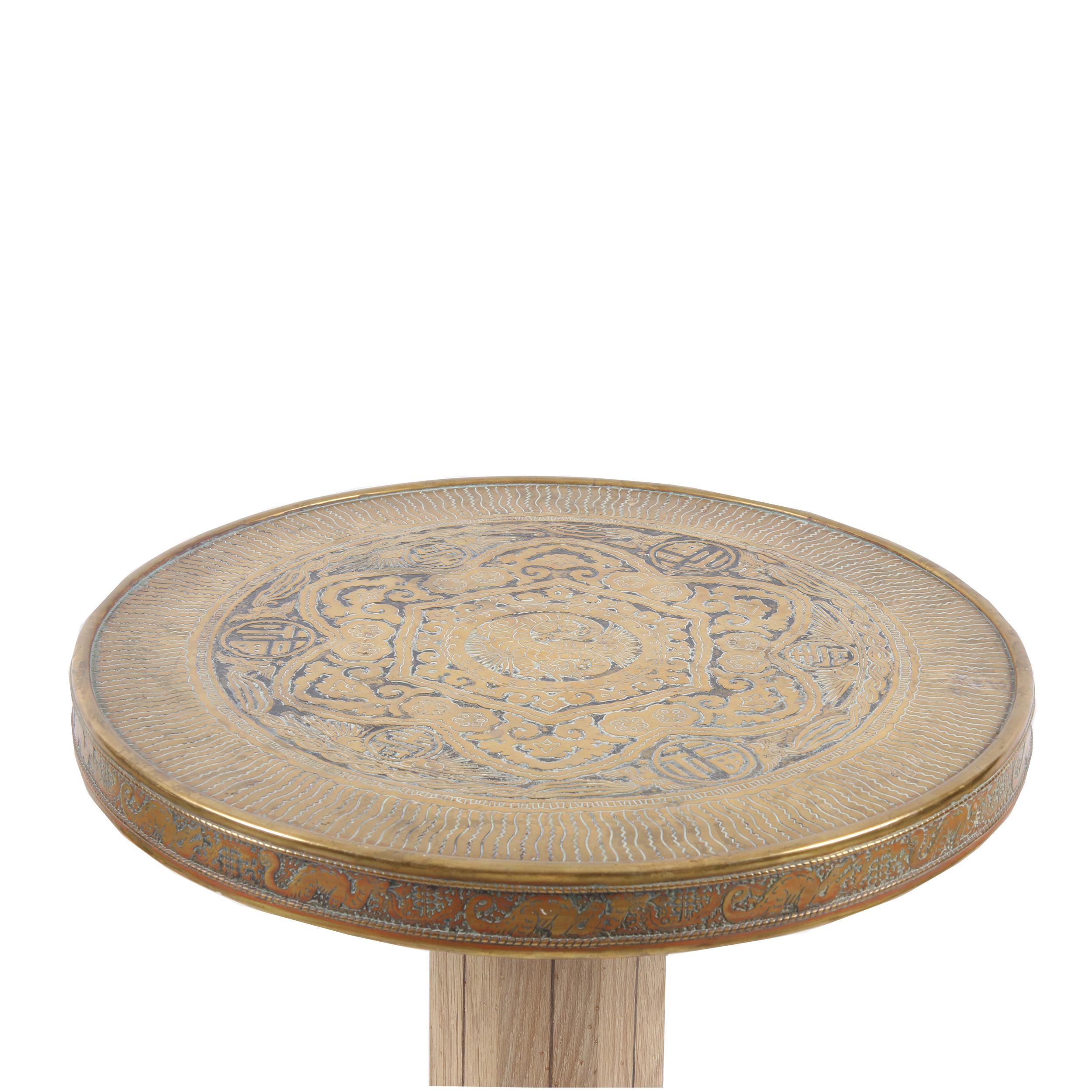 This side table features an incredibly detailed top, using the repusé method (hammered in), with dragons, birds, a sun motif and various characters. Every time you look at it, you find something new!

The base is made from ash, with a geometric