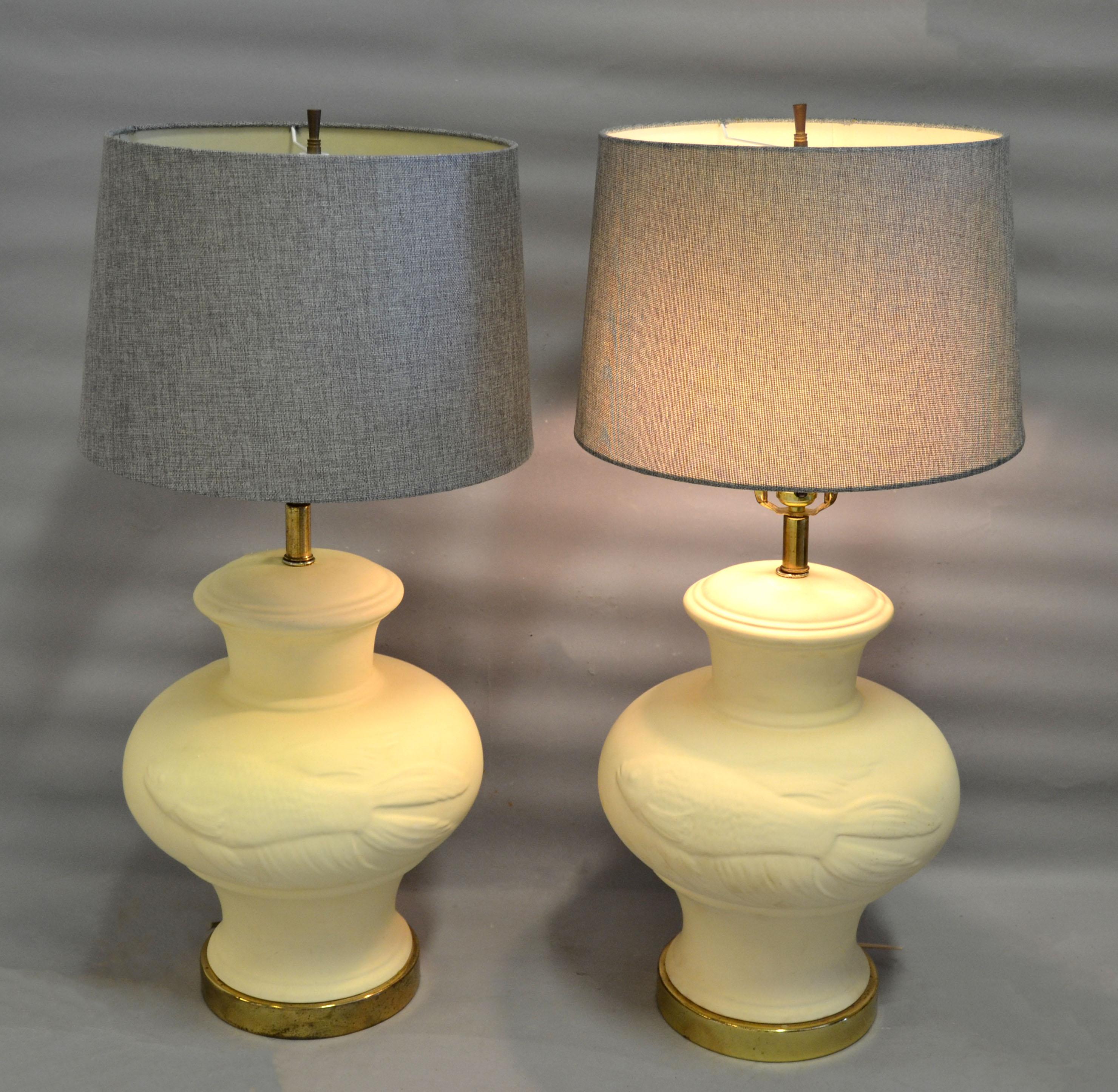 A pair of Asian style beige ceramic table lamps with brass base and Koi Fish Pattern.
Perfect working condition and each Lamp takes a regular or LED bulb.
No Shades.
   