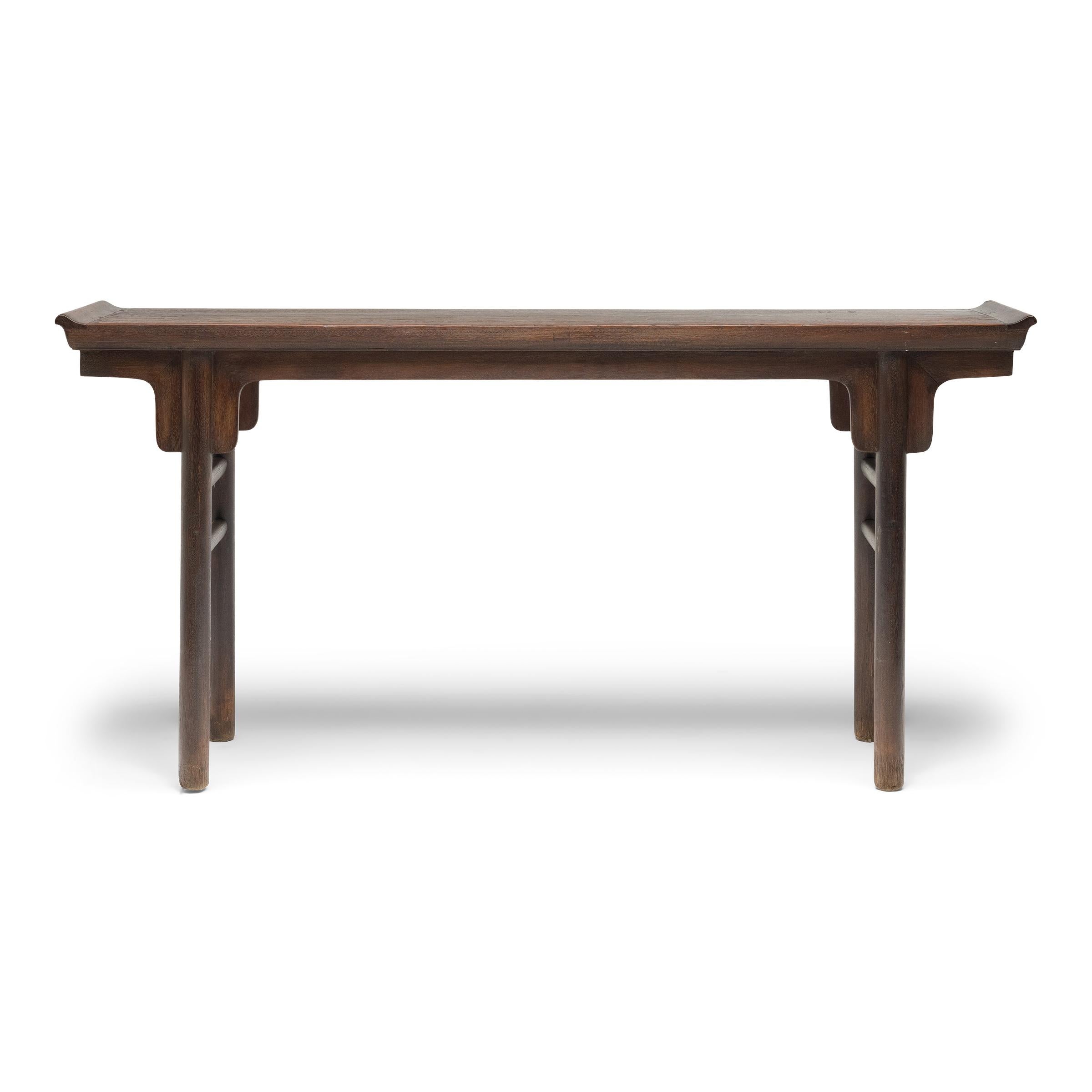 This elegant plank top altar table exemplifies the austere beauty and perfection of line that defines classical Chinese furniture. The 19th-century table would have originally been used as a home altar for ancestor worship, placed against the back