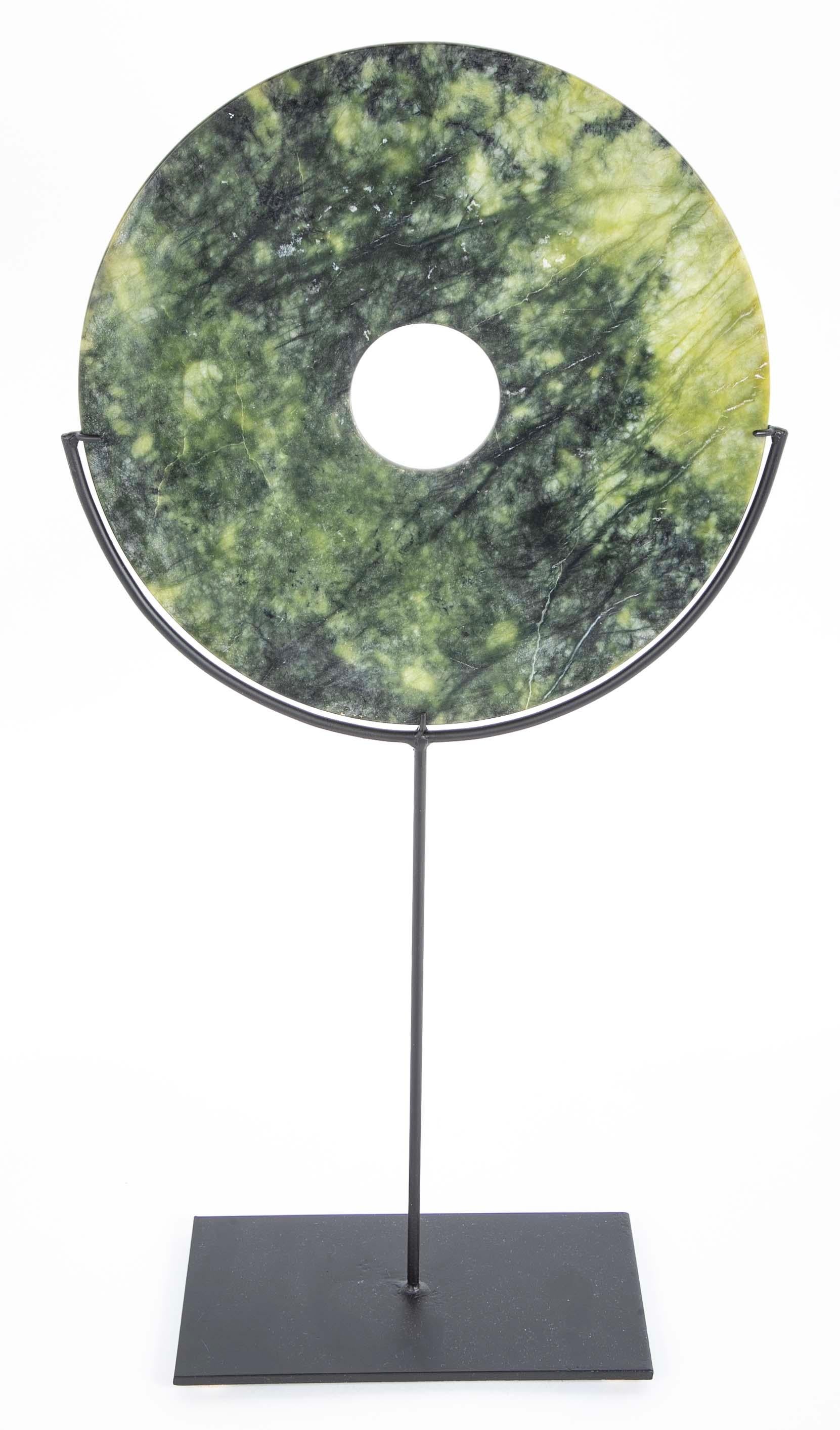 Chinese Archaistic  style hand carved jade bi disk, on custom steel stand. Ranging from deep to pale green, the darker areas appear to be a forest of trees against a white 