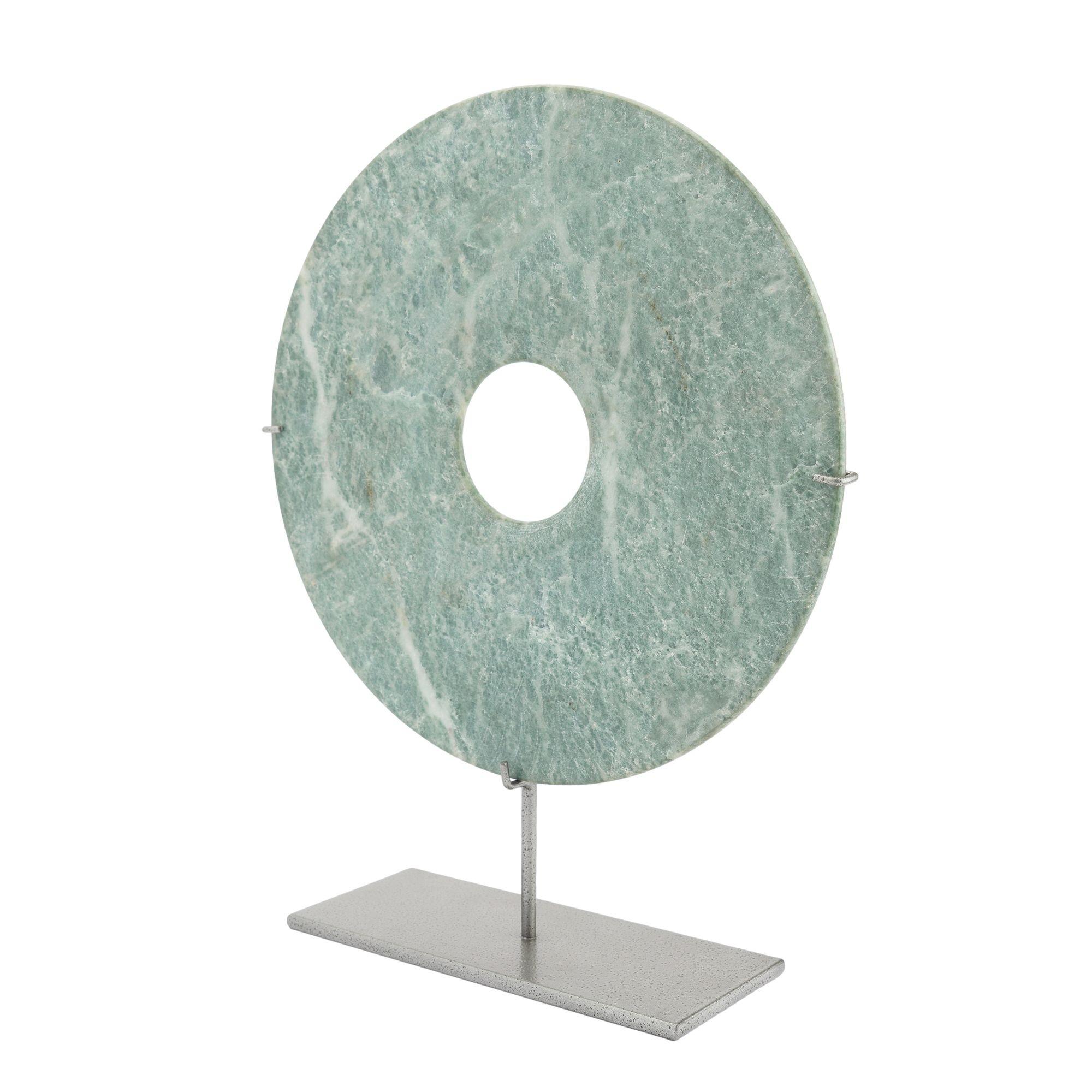 Chinese carved jade bi disc on a custom powder coated iron stand. The bi is an honorific symbol of moral quality as well as a designation of social status and was used ceremonially dedicated to persons of rank.
