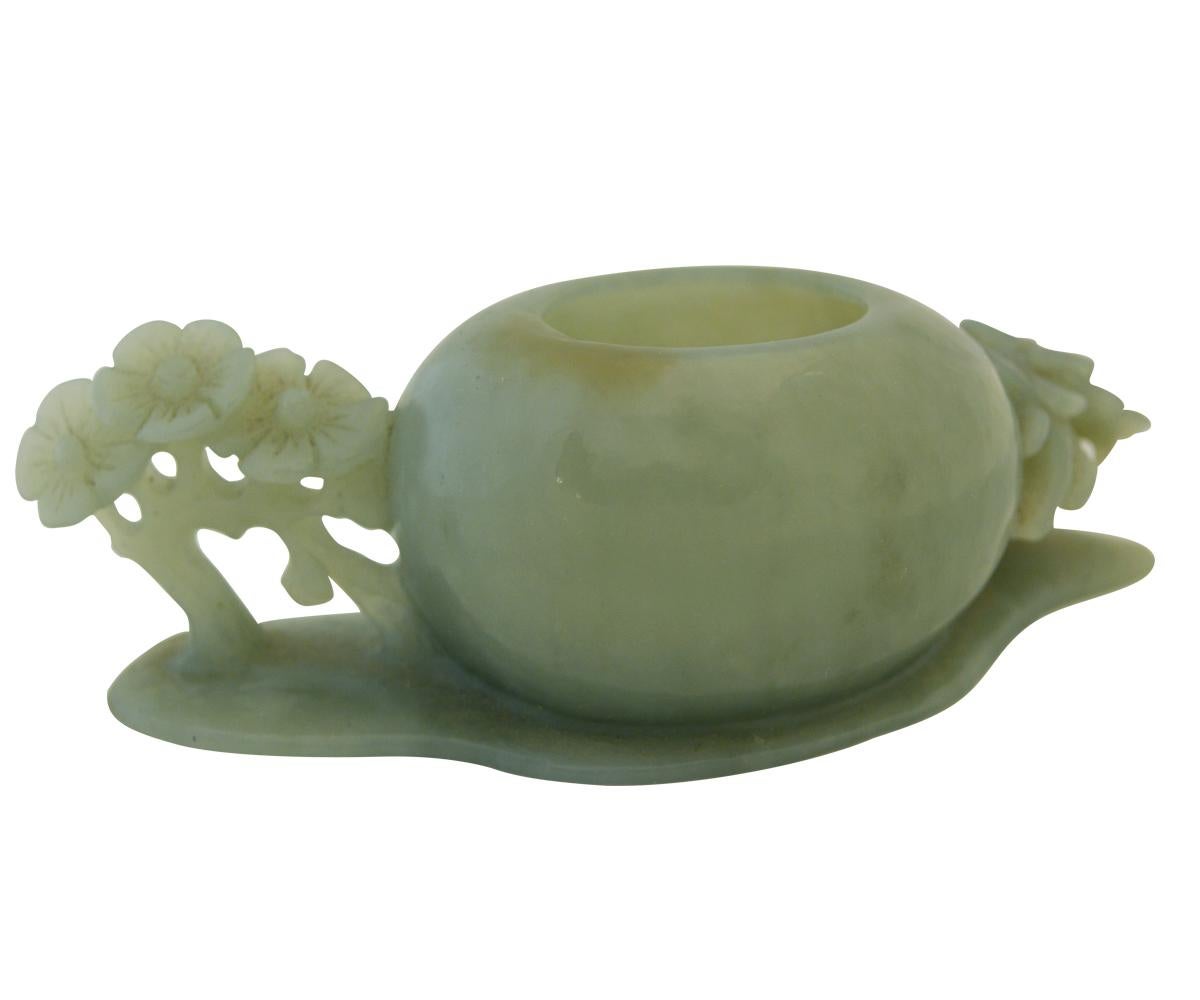 Offered is a Chinese jade brush washer that nicely cut from a translucent celadon color jade. The openwork carvings feature seven flowers carved in the round with stems originating from the washer and the base.