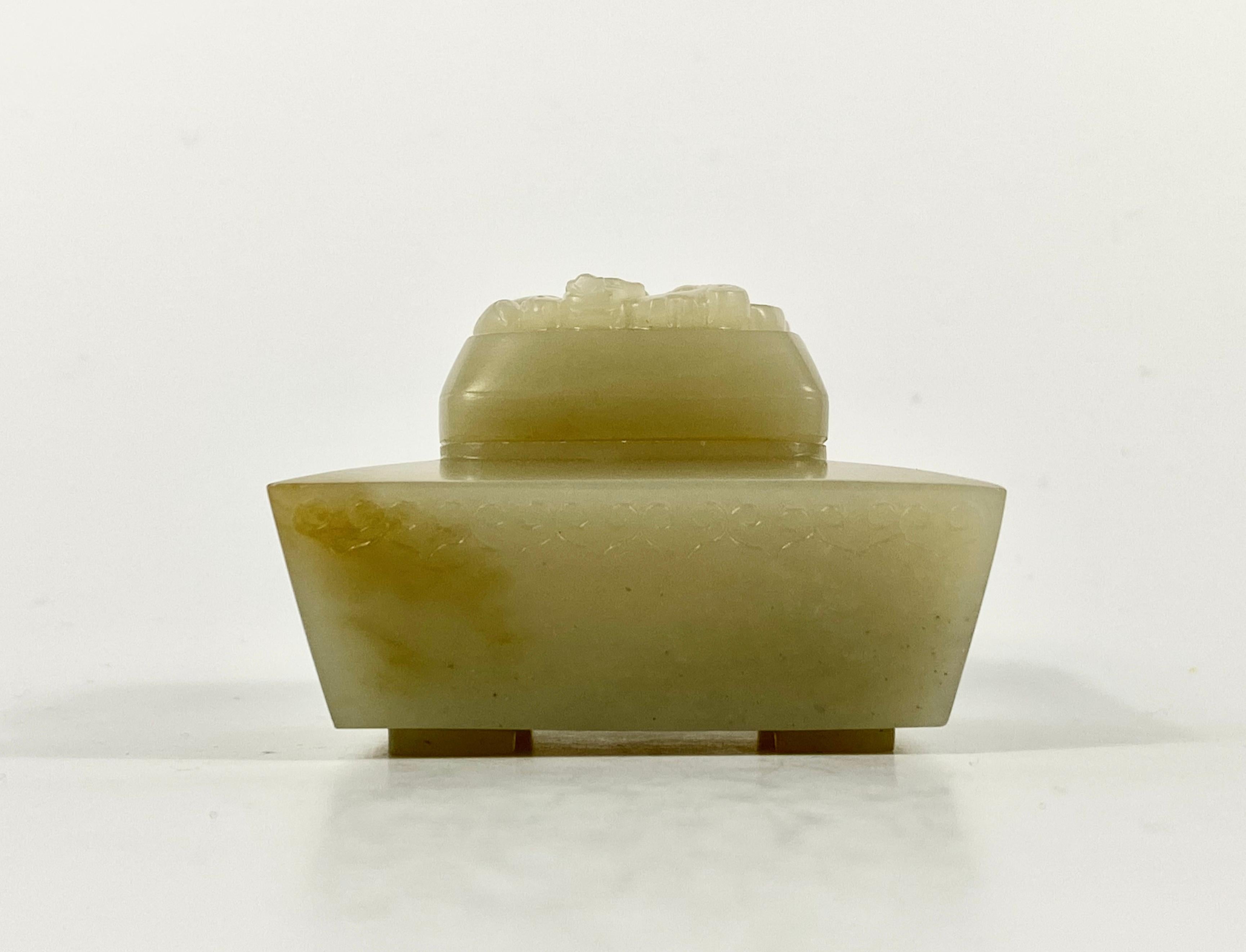 Chinese jade censer and cover, 19th century, Qing dynasty. The small square shaped base, carved with a stylised Ruyi head motif to the rim, and set upon four angled feet.
The square cover, deeply carved to the top with a coiled