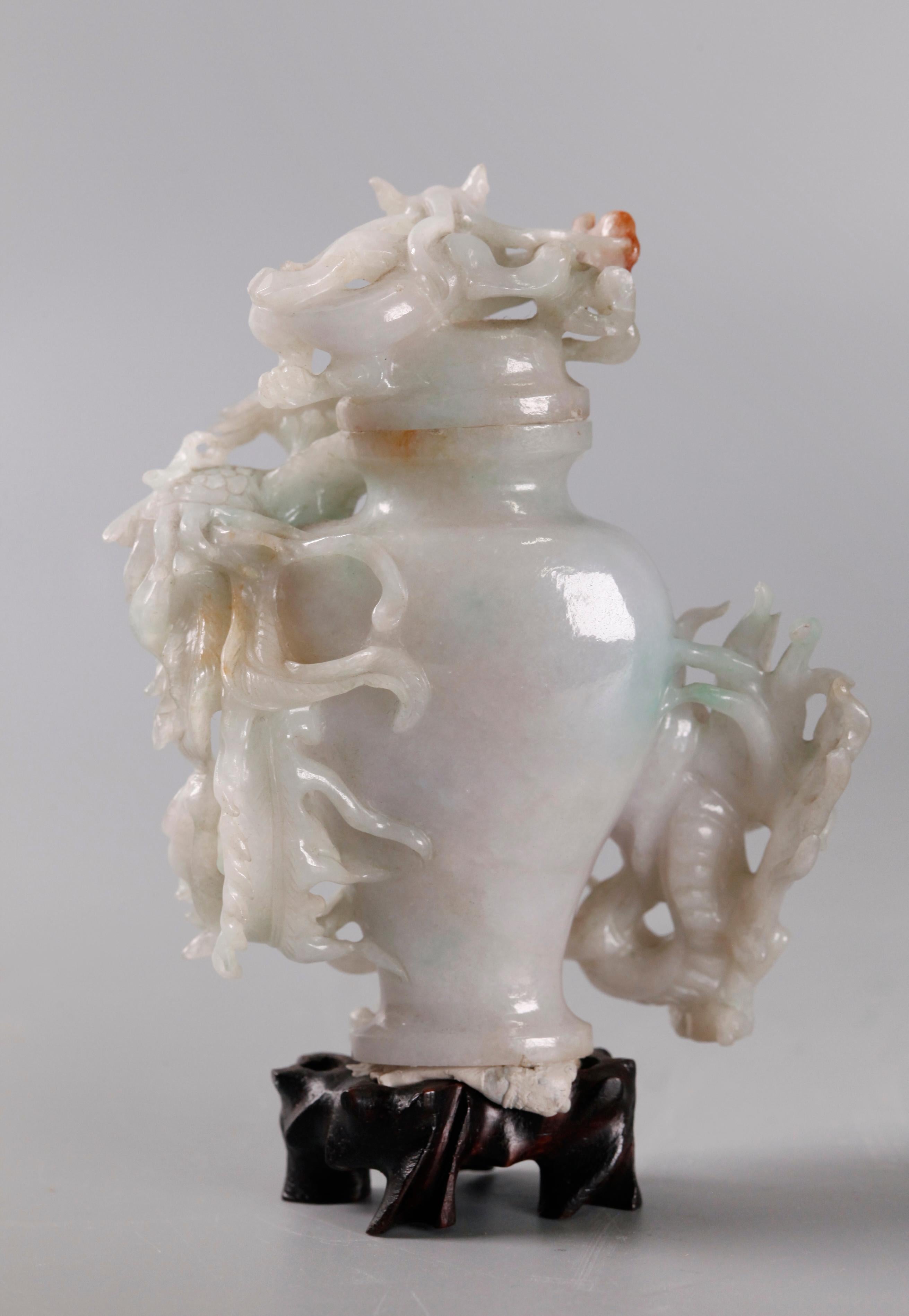 vase is carved with a dragon and a phoenix in high relief; cover is carved with a dragon in high relief; jade with russet tones; 1.5in(D) x 3.5in(W) x 4in(H) are the dimensions of the jade cover vase only; overall dimensions with wooden base: