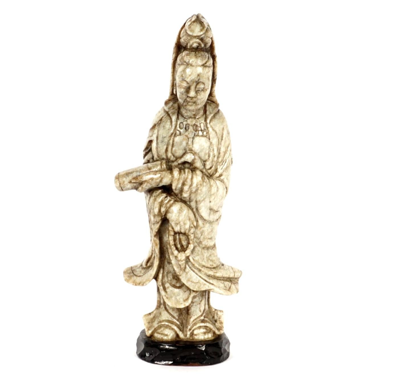 Most likely Ming 15th/16th Century, carved chicken bone jade figure of a standing Guanyin (Quanyin) holding a scroll in one hand, prayer beads in the other. Affixed to carved wood base, older label underneath, figure measures 6.75