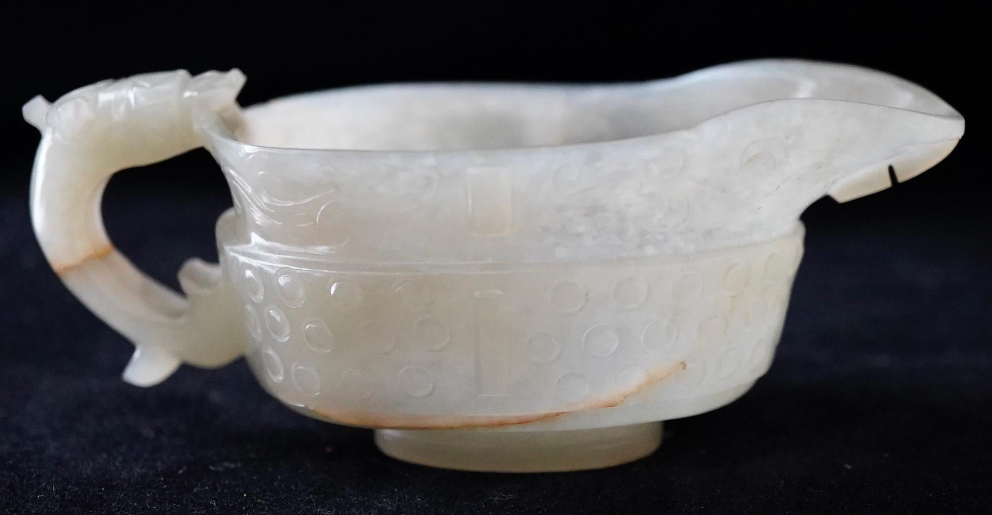 Chinese light celadon jade libation cup from early Qing dynasty. Very fine carving and decoration. 