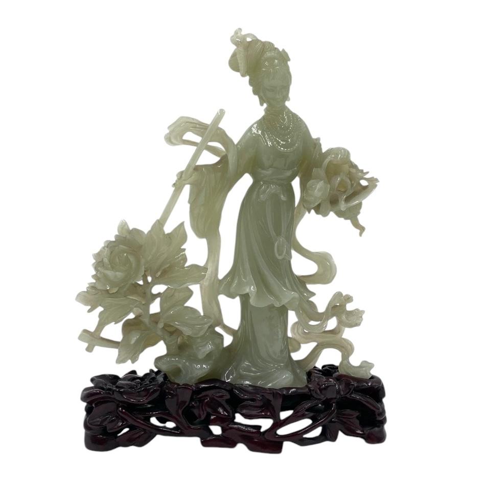Chinese Jade Lady Sculpture.

Chinese Jade Lady carved with flowers and leaves.

Circa 1950 Origin China.

Materials: jade and wooden base (fruit tree)
Chinese Jade Lady with carved flowers.

During the Han Dynasty 200 BC to 200 AD jade carving was