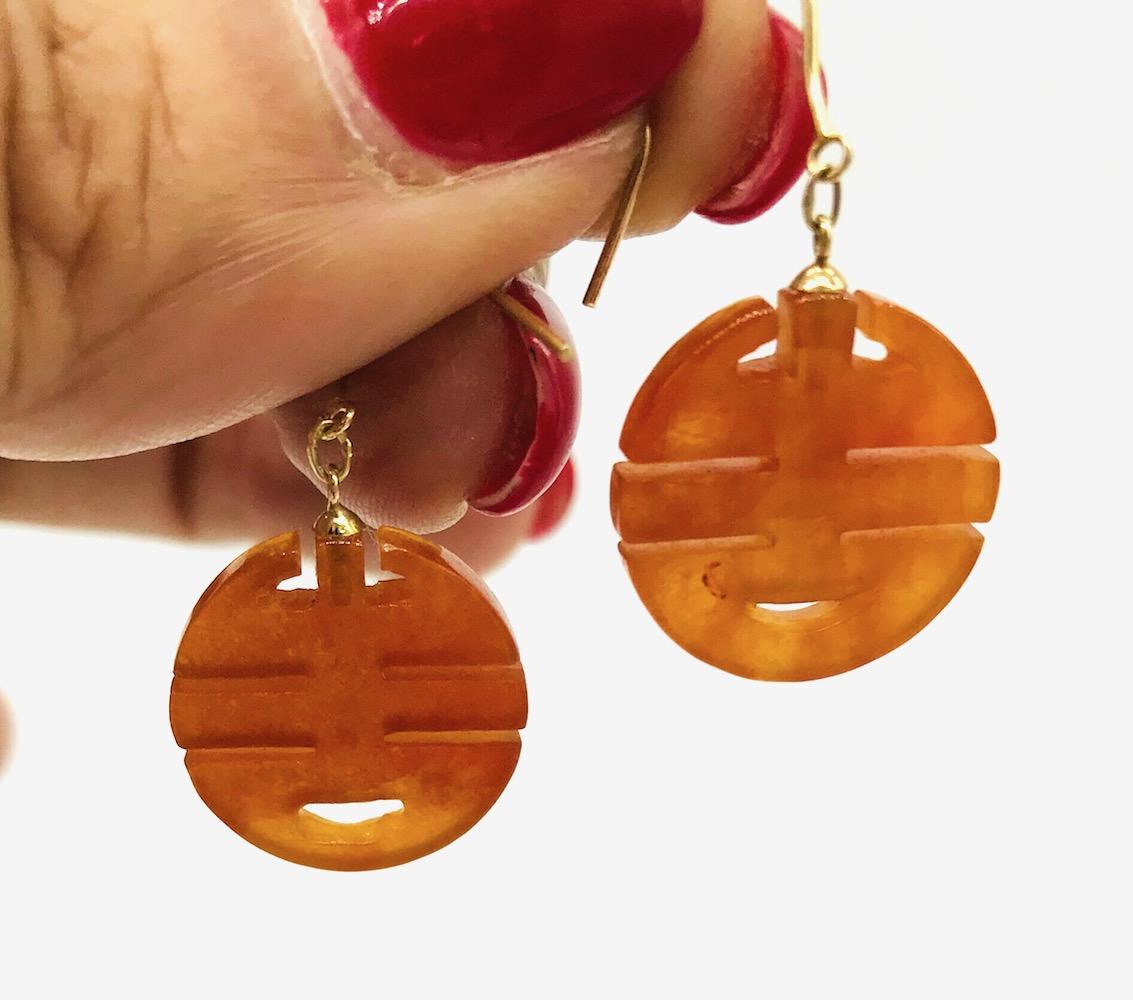 Chinese, Jade Orange 14 karat yellow gold Earrings
Chinese symbol earrings are 18 mm in diameter and suspended by a hook-style earring. 
GIA Gemologist Inspected and Evaluated