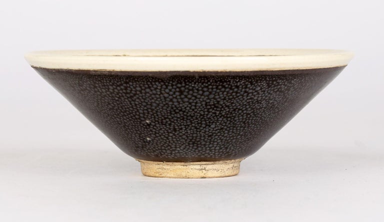 A very impressive and stylish Chinese black shagreen pattern glazed pottery tea bowl in the Jian Ware style believed to date from the 20th century or possibly earlier. The round tea bowl stands on a narrow round unglazed foot and is finely decorated