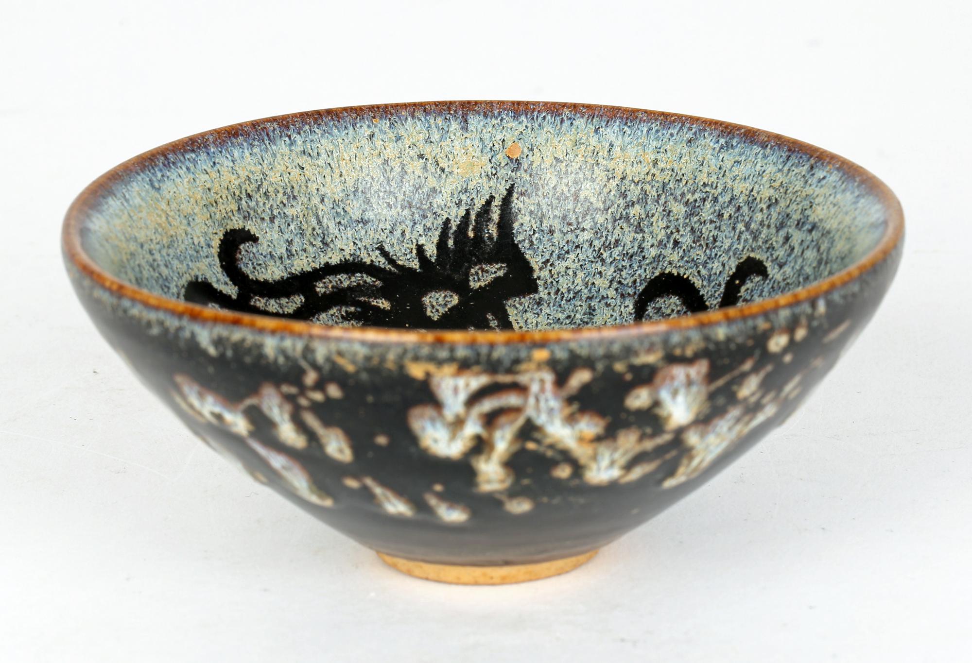 A very impressive and stylish Chinese glazed pottery tea bowl decorated with ho-ho birds in the Jian Ware style and believe to date from the 20th century or possibly earlier. The round tea bowl stands on a narrow round unglazed foot and is finely