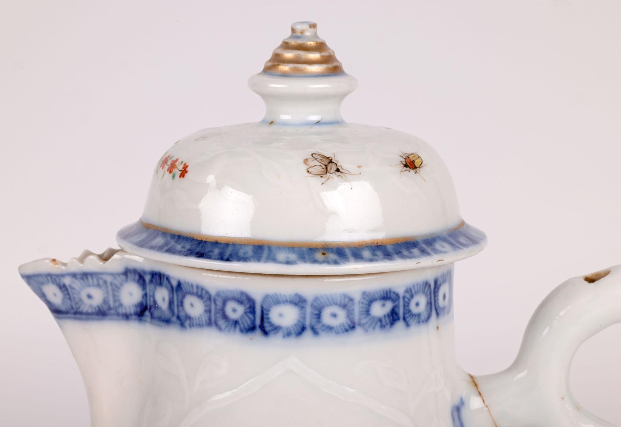 An unusual Chinese Kangxi period (1662-1722) porcelain lidded and handled jug embossed with flowers and hand painted in the European style. The jug stands raised on a narrow round foot rim with a round bulbous body and funnel shaped top with a bird