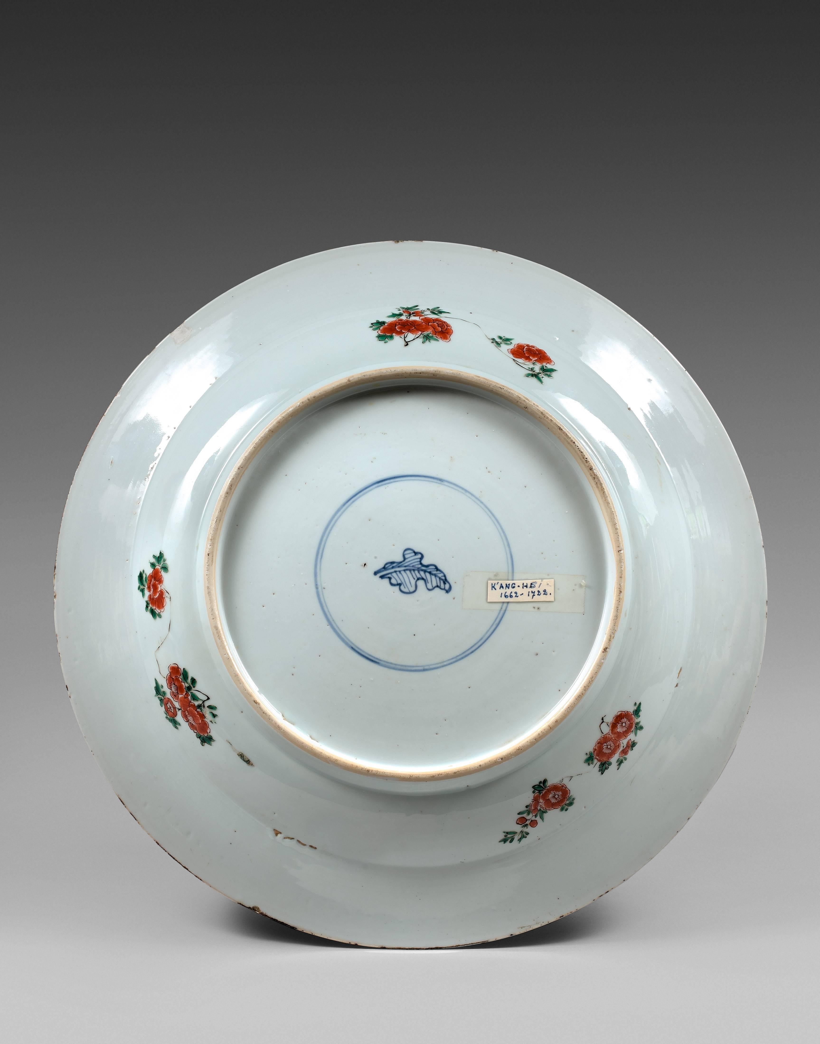 This dish is part of a group a unusual dishes en Famille verte porcelain with the cavetto decorated with flying crane medallions on a red wickerwork ground. The center of the dish depicts a scene of the book 6 of 