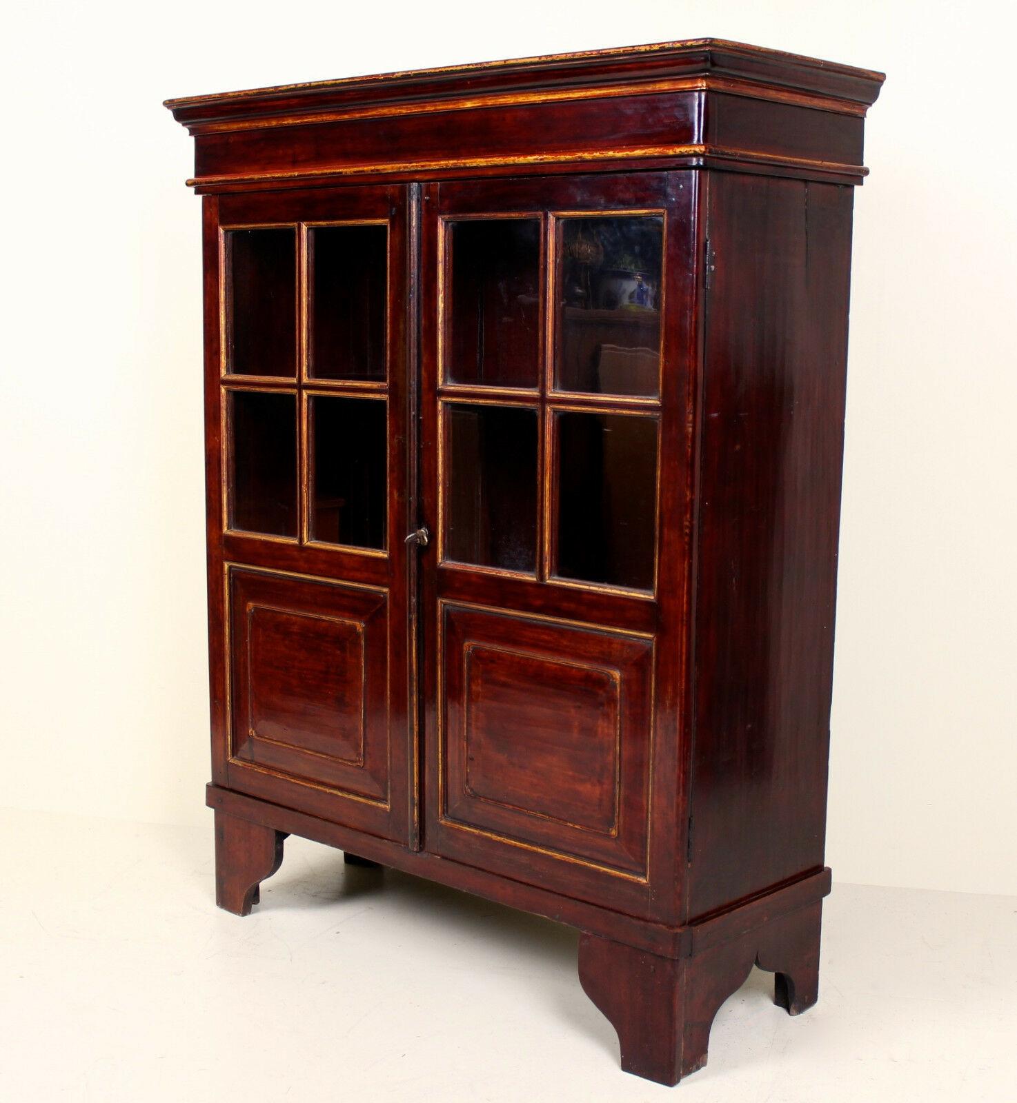An impressive Chinese lacquered glazed bookcase.

The flared cornice above astragal glazed paneled doors enclosed shelving and storage and raised on carved bracket feet.

Complete with original key: the lock mechanisms in smooth working order.