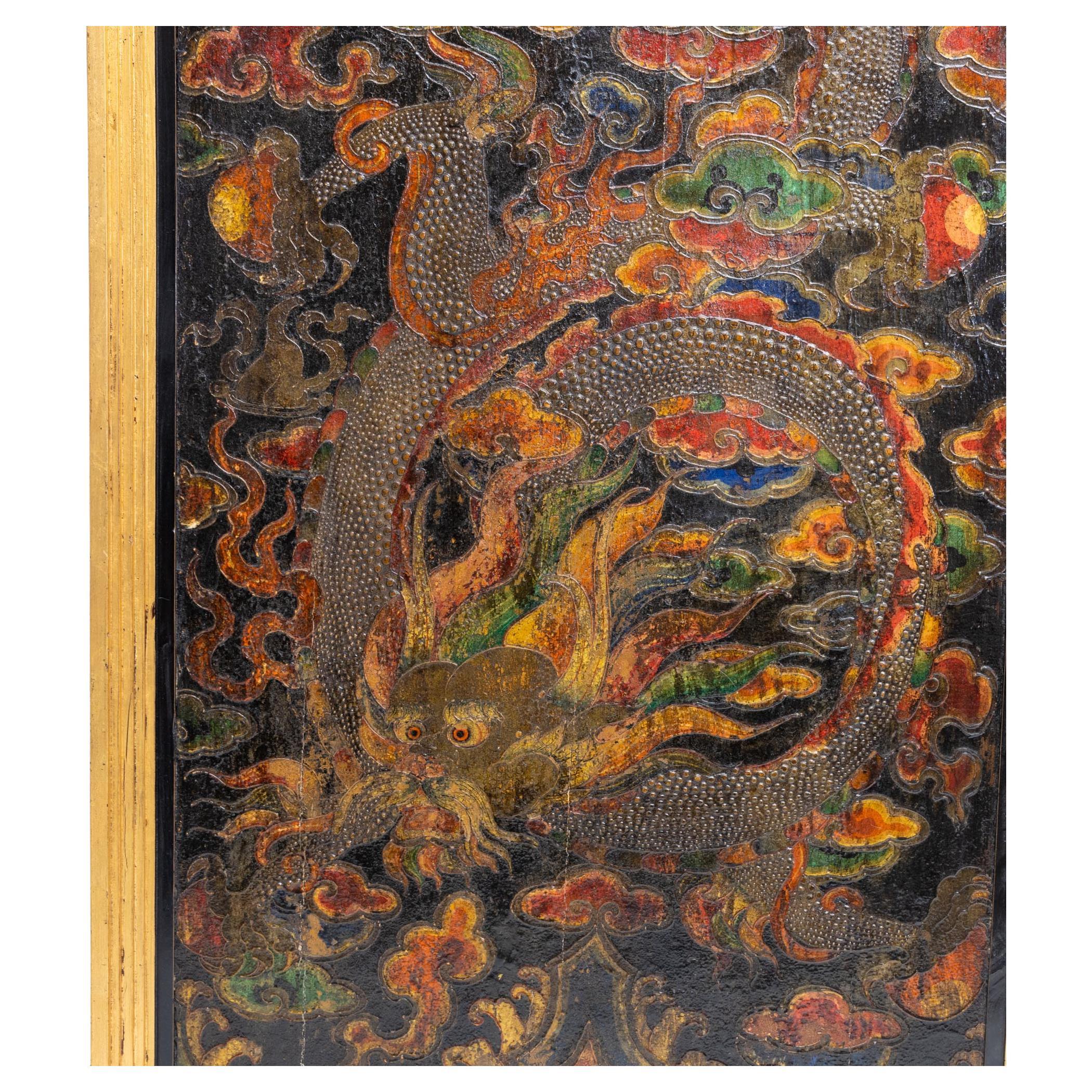 Chinese lacquer panel with dragon decoration.