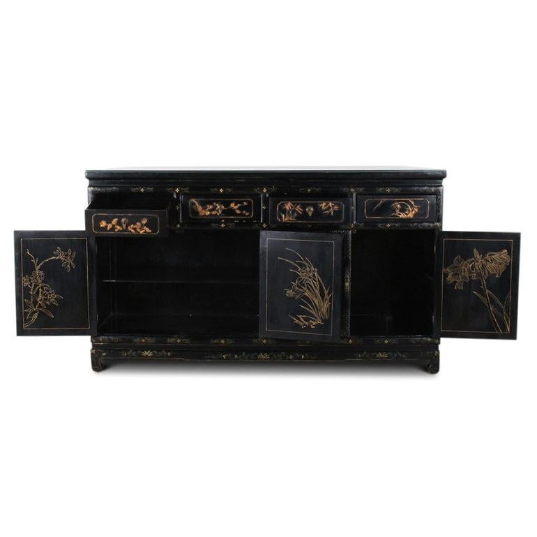 A vintage Chinese sideboard, or cabinet, with four drawers over four cabinets, the black lacquered case decorated with painted and applied decoration depicting flowers, birds, etc, circa 1950.


 
 