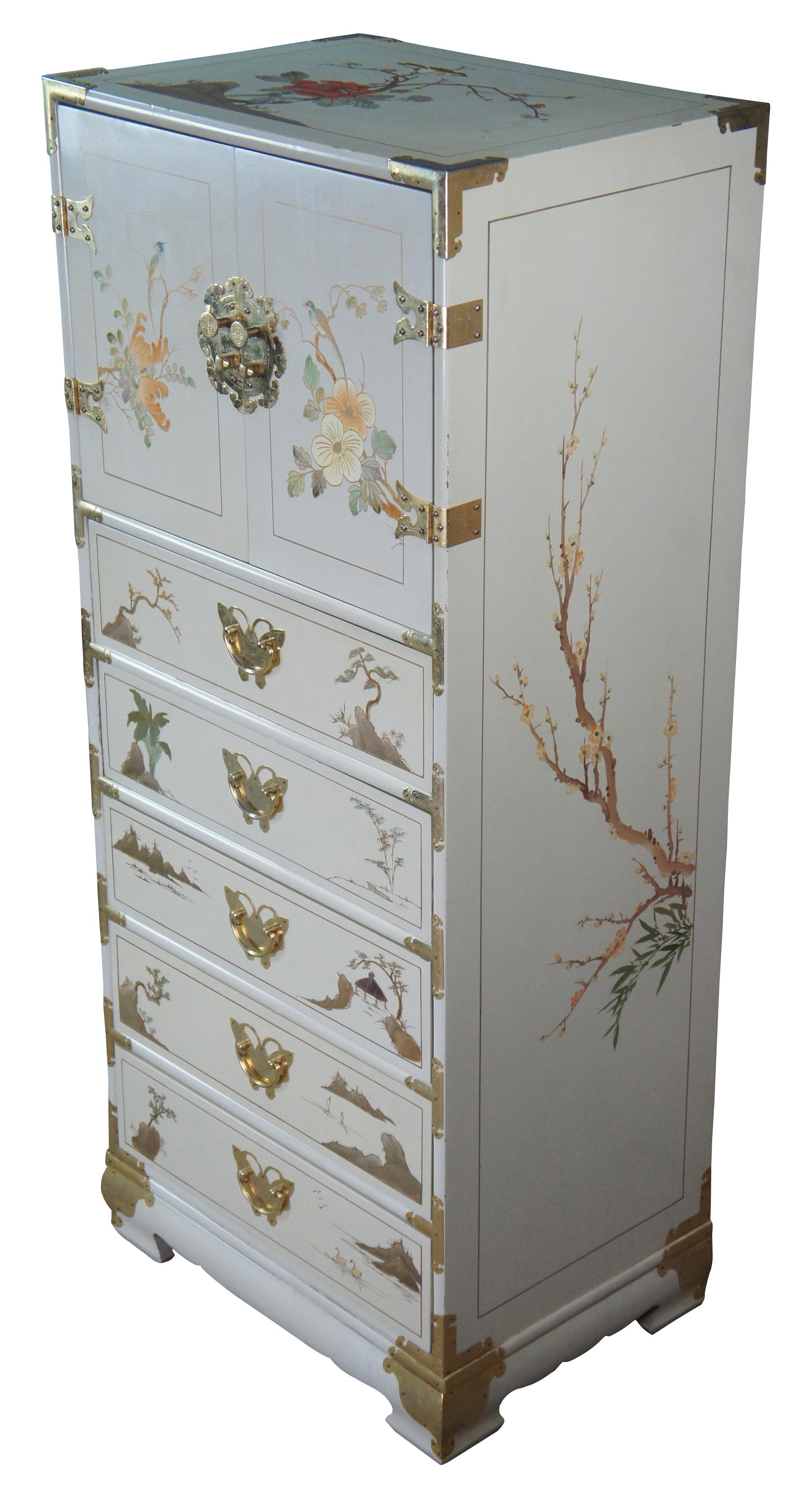 Chinese jewelry armoire, chest or dresser featuring hand painted detail of pagodas, landscapes, birds, and florals with brass banded accents and butterfly pulls. Circa lst half of 20th century.
 