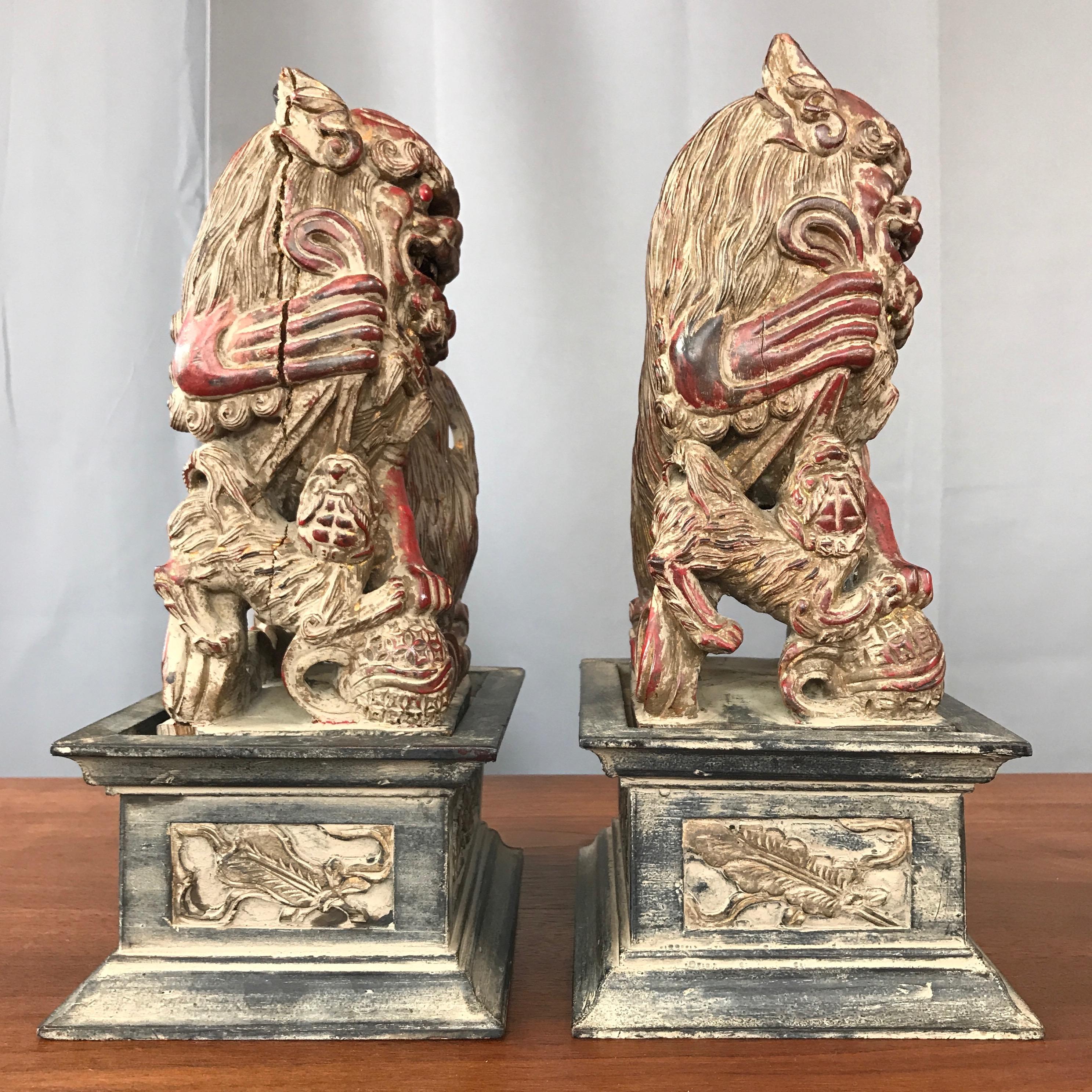 Early 20th Century Chinese Lacquered and Giltwood Guardian Lions on Pedestals, a Pair