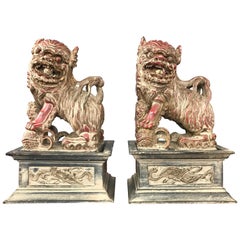 Antique Chinese Lacquered and Giltwood Guardian Lions on Pedestals, a Pair
