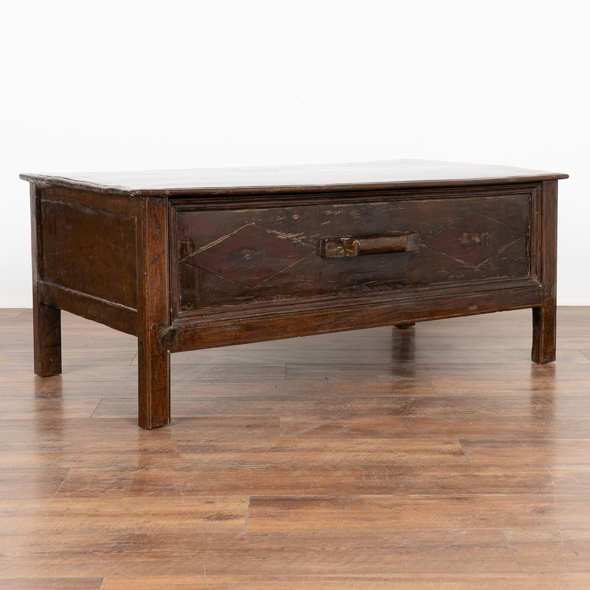 Chinese elmwood lacquered coffee table with single large, deep drawer.
Strong, stable and ready for use. 
Any scratches, cracks, dings, nicks, loss/bubbling to lacquer are reflective of age and do not detract from the beauty nor function of this