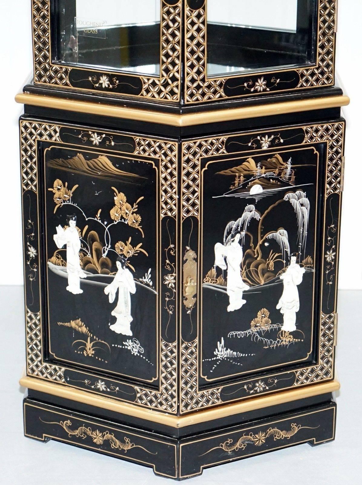 We are delighted to offer for sale this lovely hand made in China black lacquered display cabinet

Expertly crafted, the detail is sublime, its gold leaf painted with mother-of-pearl inlay, ab exceptionally high quality and decorative piece.

We