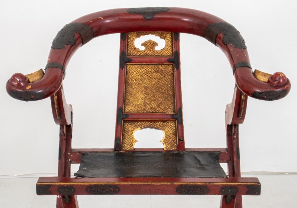 Chinese brass mounted lacquered folding horseshoe chair, late Qing Dynasty style, of typical form with round back and splat above shaped seat on high legs with footrest. 

Dimensions: 40