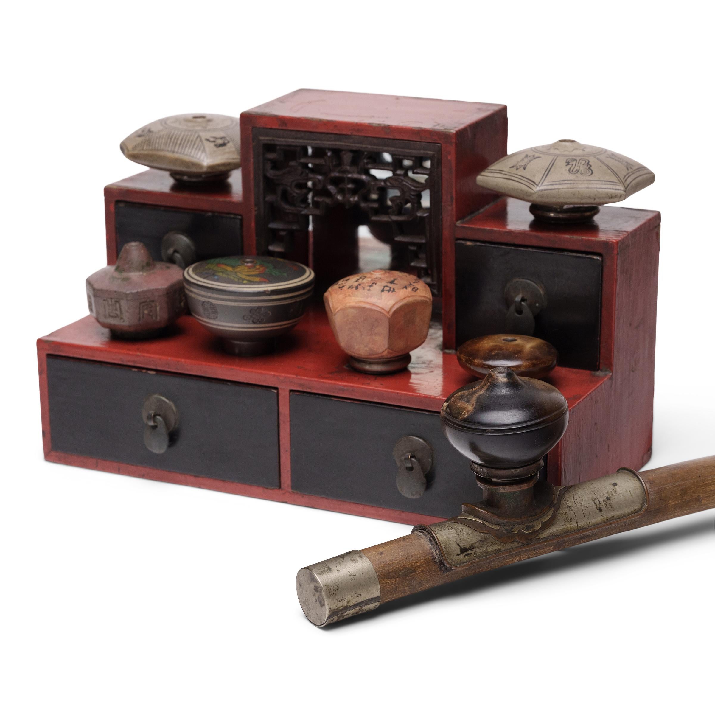 This tabletop display stand was once used to elevate an opium smoker's collection of pipe bowls, a removable element of the opium pipe often made of fine materials such as jade, yixing red clay, or agate. Pipe bowls were placed stem-down into each