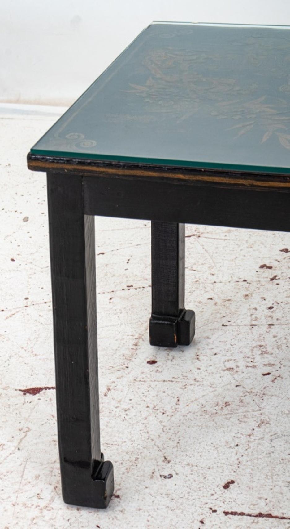 Chinese black and gold lacquered panel low table, with rectangular top with courtly scenes above four black lacquer elephant trunk legs.

Dimensions:   18