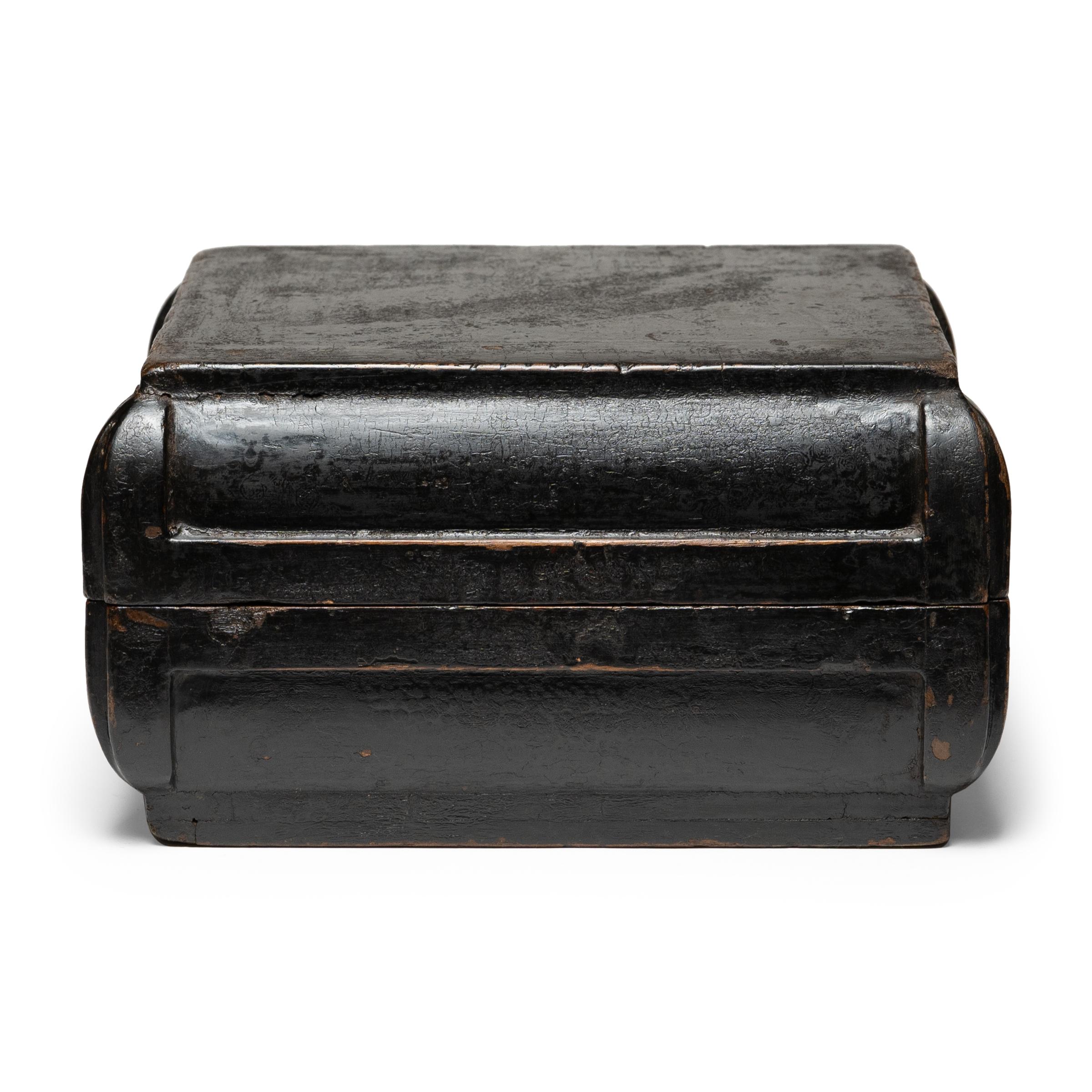 This simple lacquered container was once used as a 19th-century snack box, presented as a gift during holidays and special occasions. To the delight of the recipients, the unassuming box would have opened to reveal a bounty of popular snack foods,