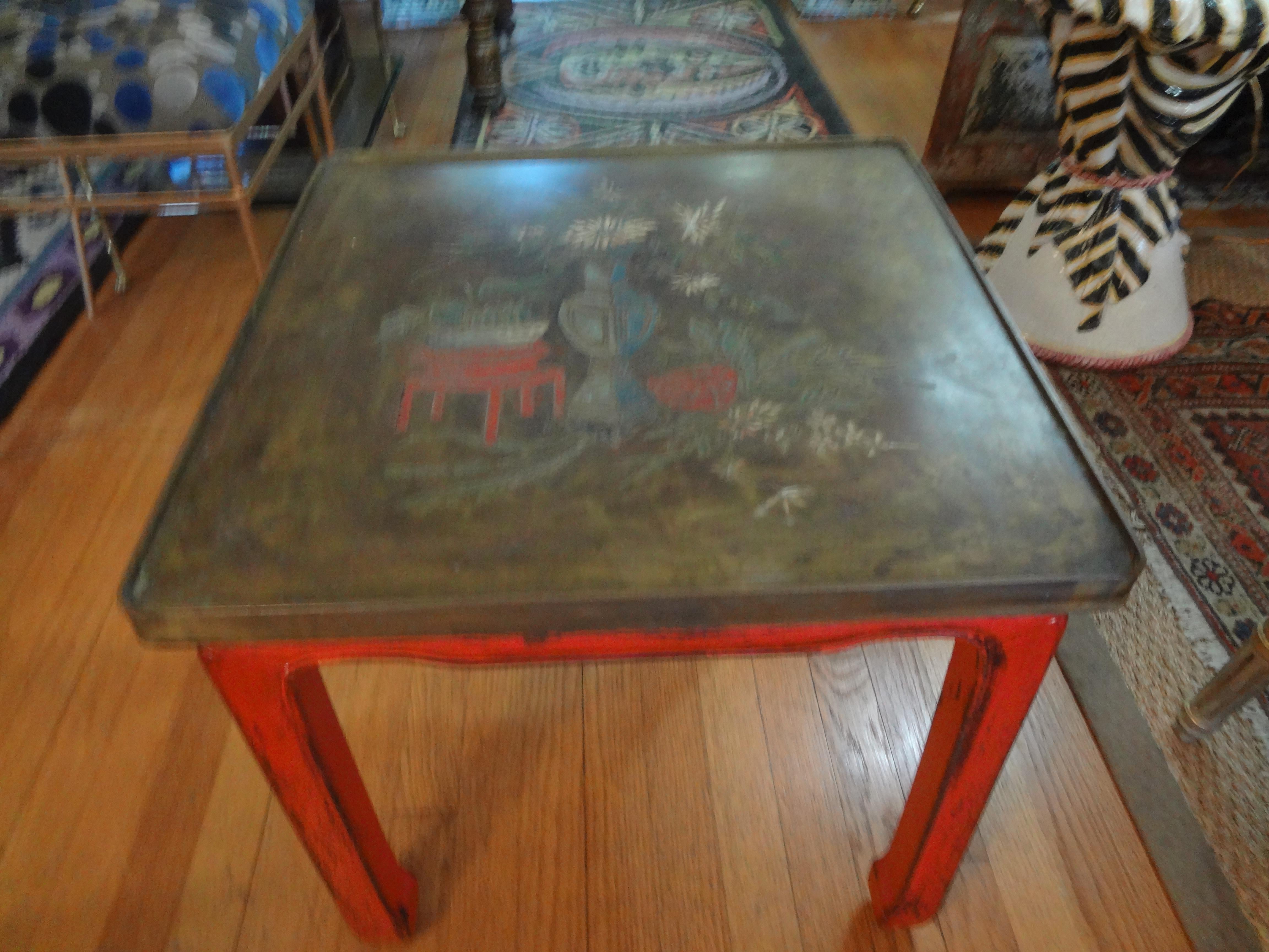 Chinese red lacquered table with beautifully etched bronze top. This gorgeous chinoiserie style side table, tray table, drinks table or gueridon has a lovely etched Asian design in the manner of Philip and Kelvin LaVerne and dates to the 1960s.