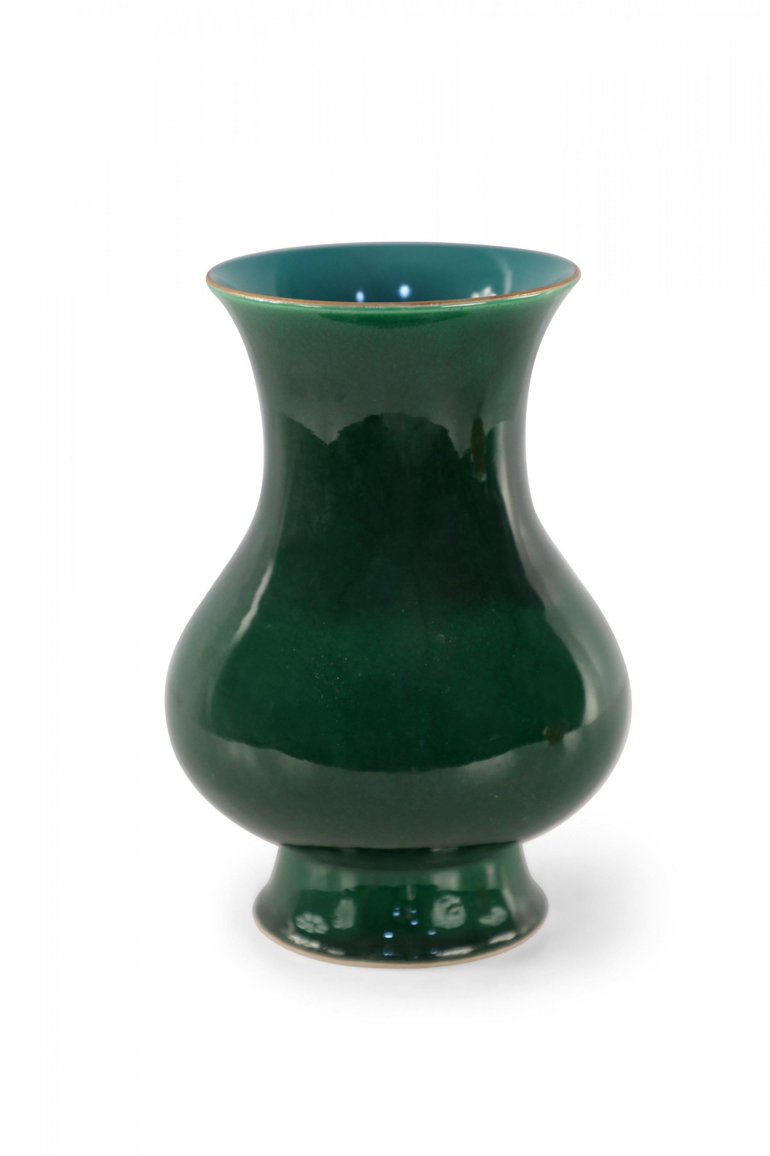 Chinese bulbous footed porcelain vase crafted in the Lang kiln (Langyao) in a dazzling and uniform emerald green glaze with a strong glass-like luster, shifting to a subtly varied light blue on the interior.