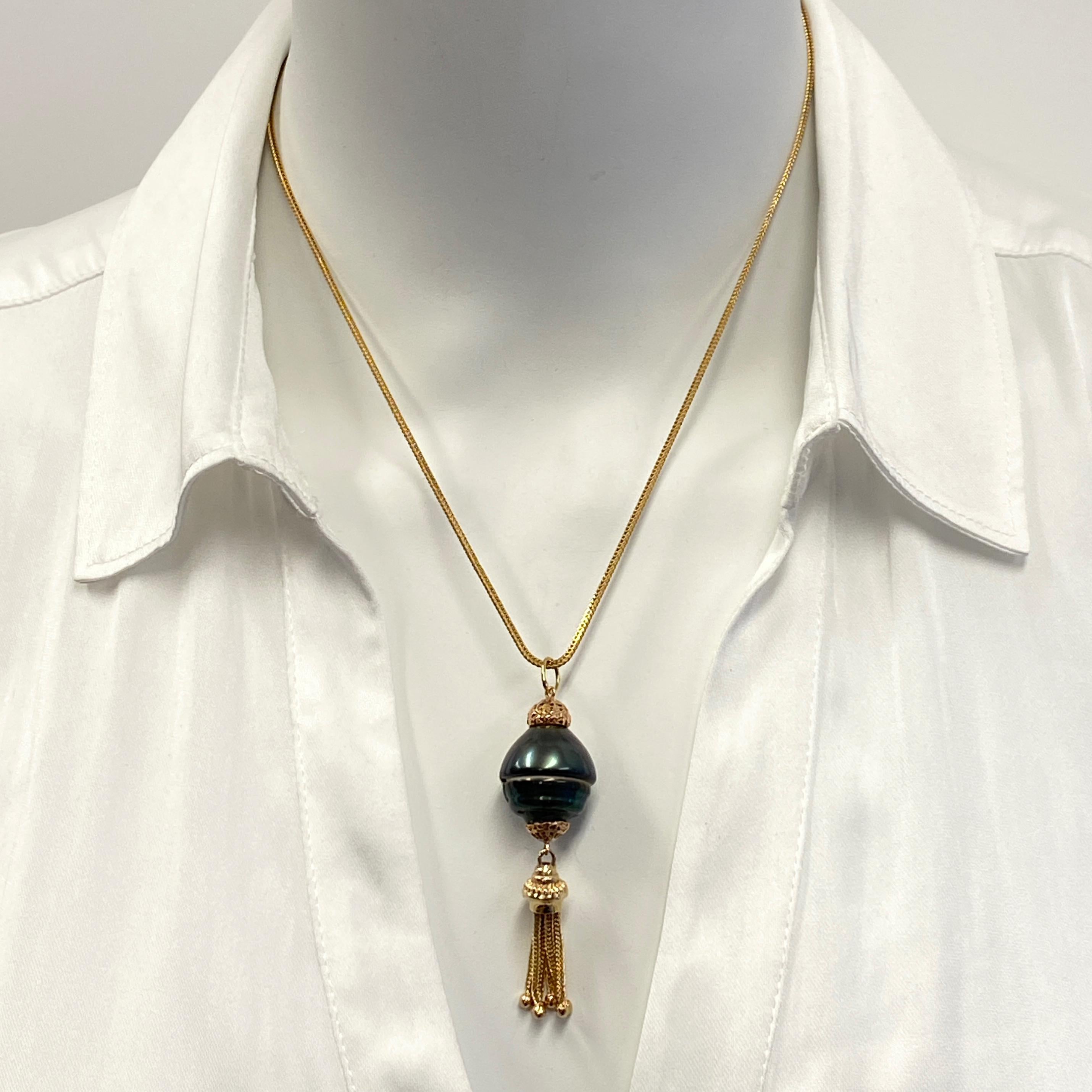 This funky, one-of-a-kind pendant features an unusual and very baroque green Tahitian pearl.  

Eytan Brandes played up the pearl's unique silhouette with vintage components -- rose gold caps and a yellow gold tassel -- and created a gorgeous little