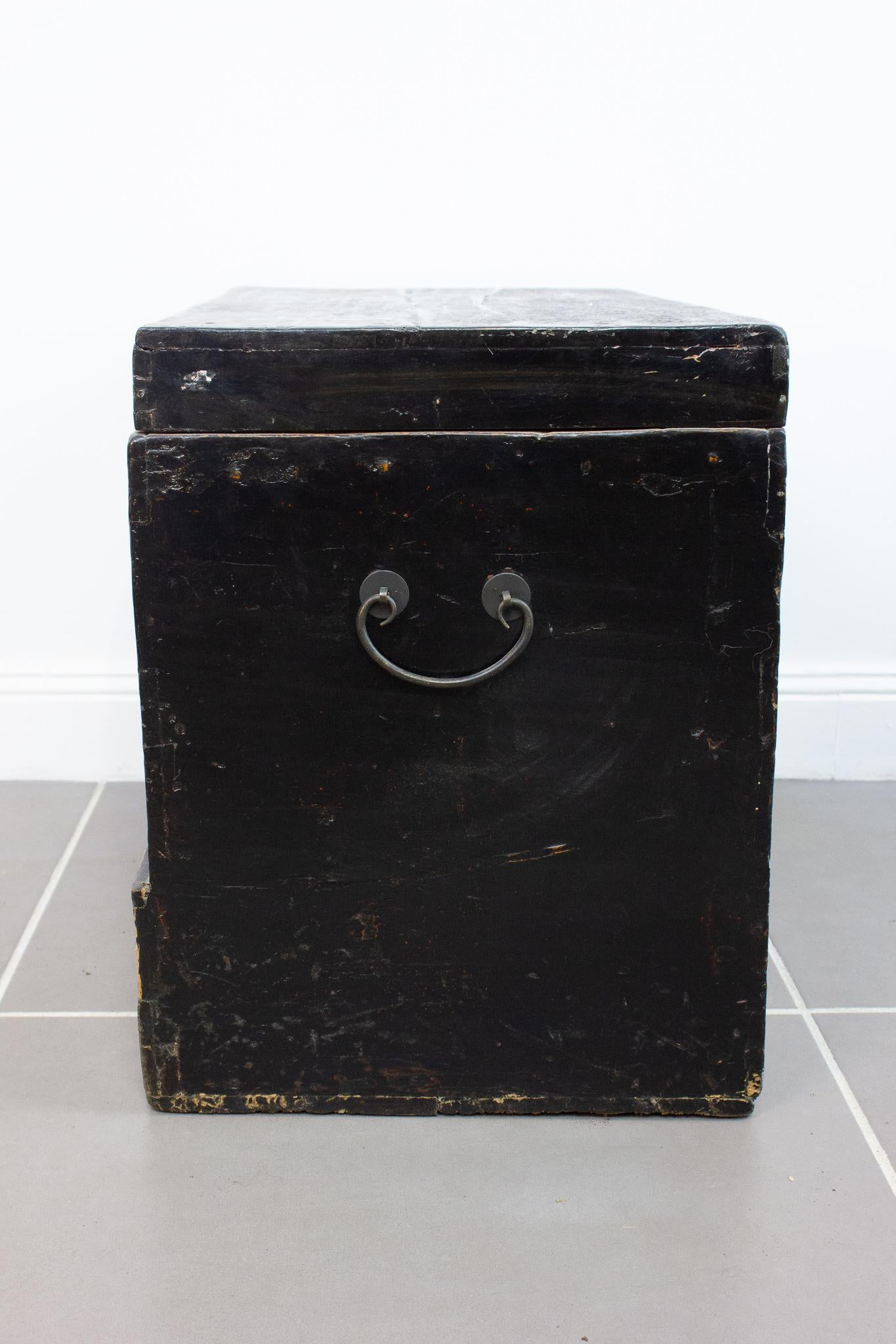 Charming Chinese chest in lacquered wood dating from the end of the 19th / beginning of the 20th century. This trunk is strongly marked by its Asian appearance, particularly at the level of the lock and the handles. It is decorated with flower
