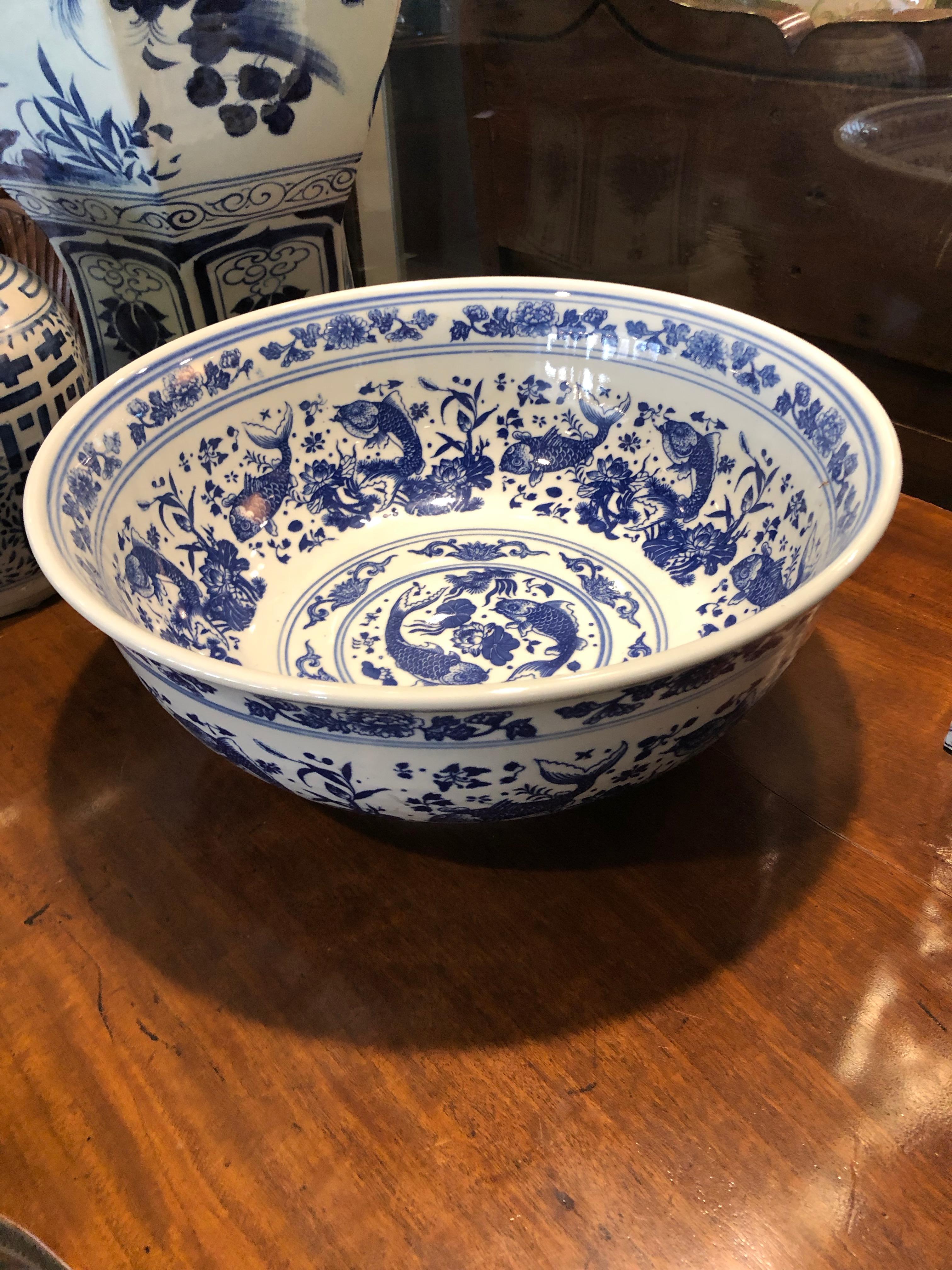 Large Chinese punch bowl hand panted fish and foliage design. Having a chop mark to the back having the Qianlong (1644-1912) mark.
 