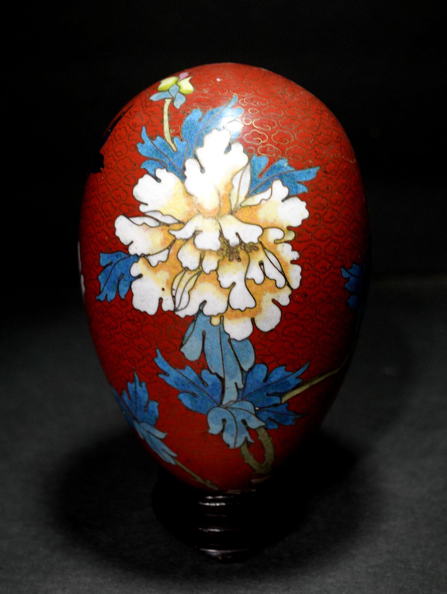 Presenting a large and beautiful Chinese cloisonné enamel egg depicting flowers and bird with a wood stand, early 20 century.