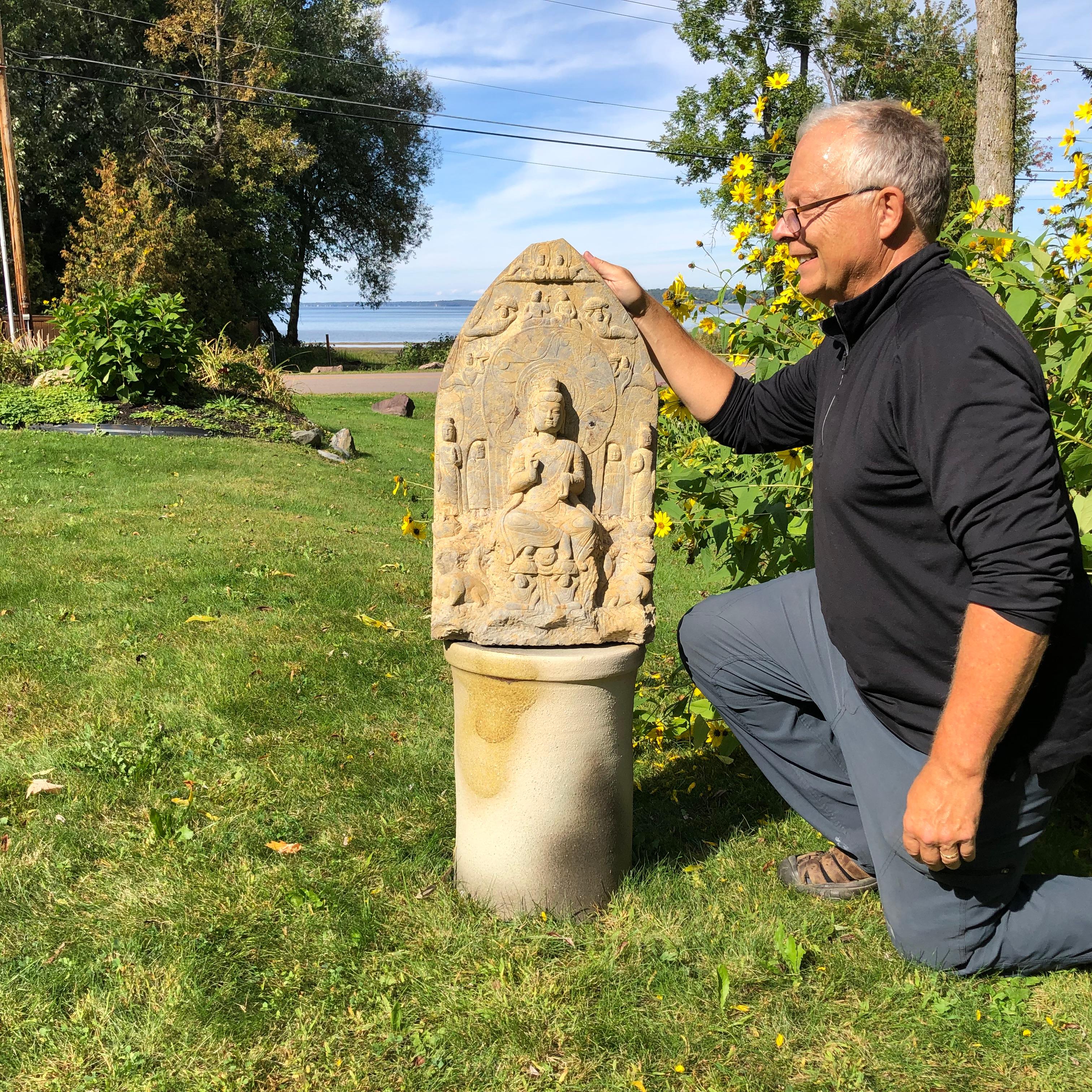 This beautiful Buddha sculpture will bring serenity and timeless style to your home, office, sacred space, or garden

This substantial older hand carved sculpture with a prolific carving of the Buddha with Guan Yin and Classic attendants comes