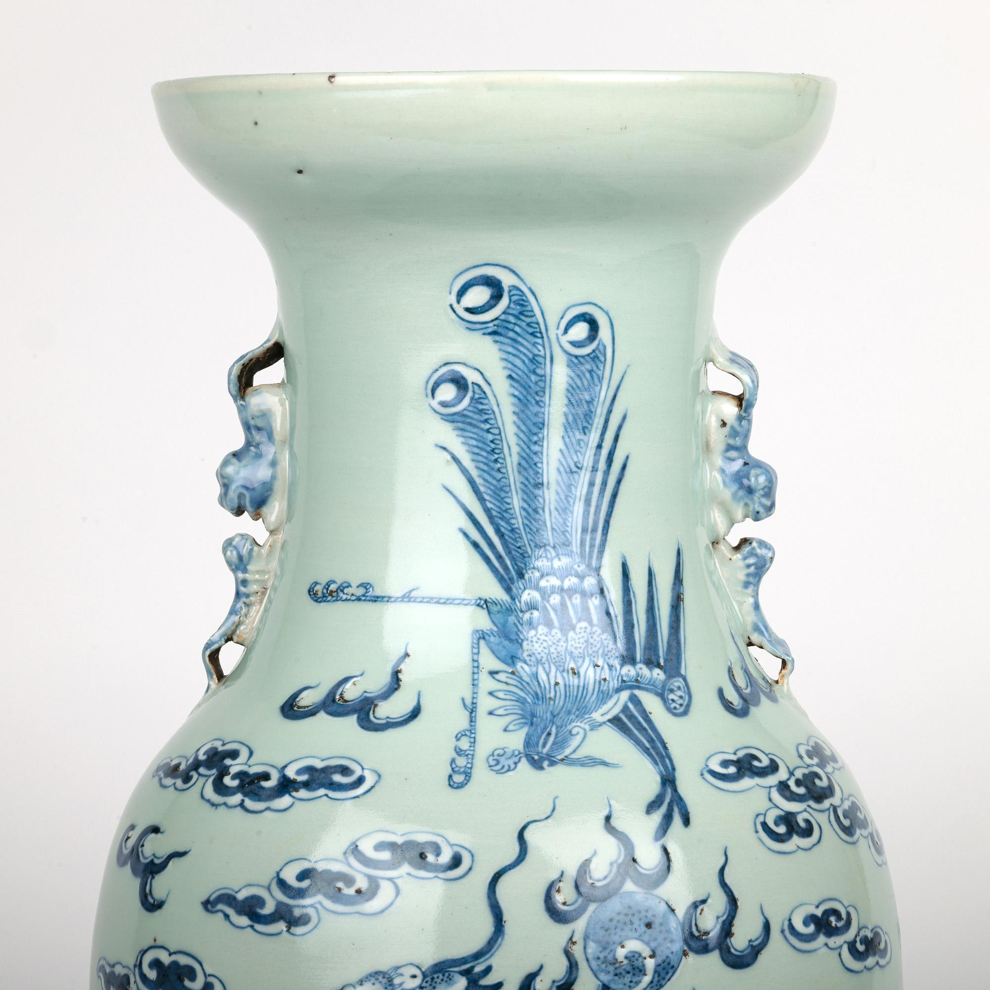 A large and impressive antique Chinese Qing Dragon & Ho Ho Bird chasing a flaming pearl decorated vase dating from the 19th century. This finely potted porcelain vase is of large baluster shape standing raised on a round unglazed foot rim with a