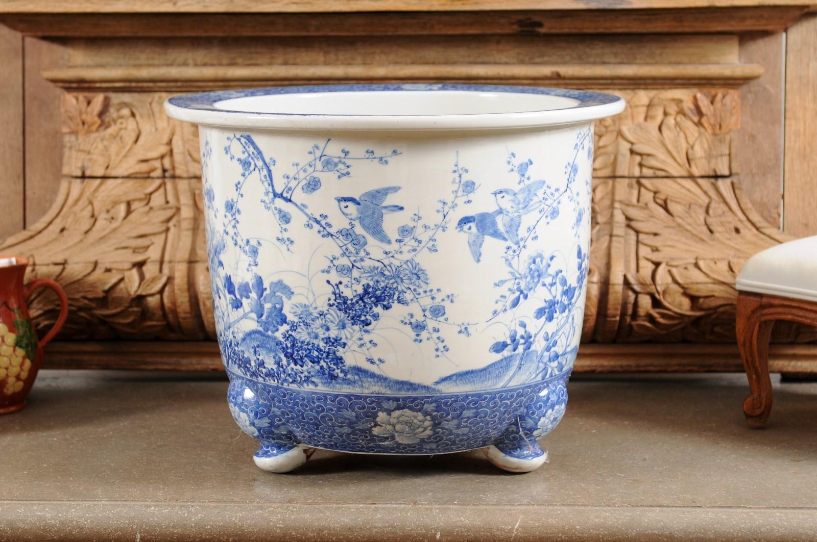 A Chinese blue and white planter from the late 19th century, with herons, birds and flowers. Created in China during the later years of the 19th century, this planter features a circular body beautifully adorned with a blue and white decor depicting
