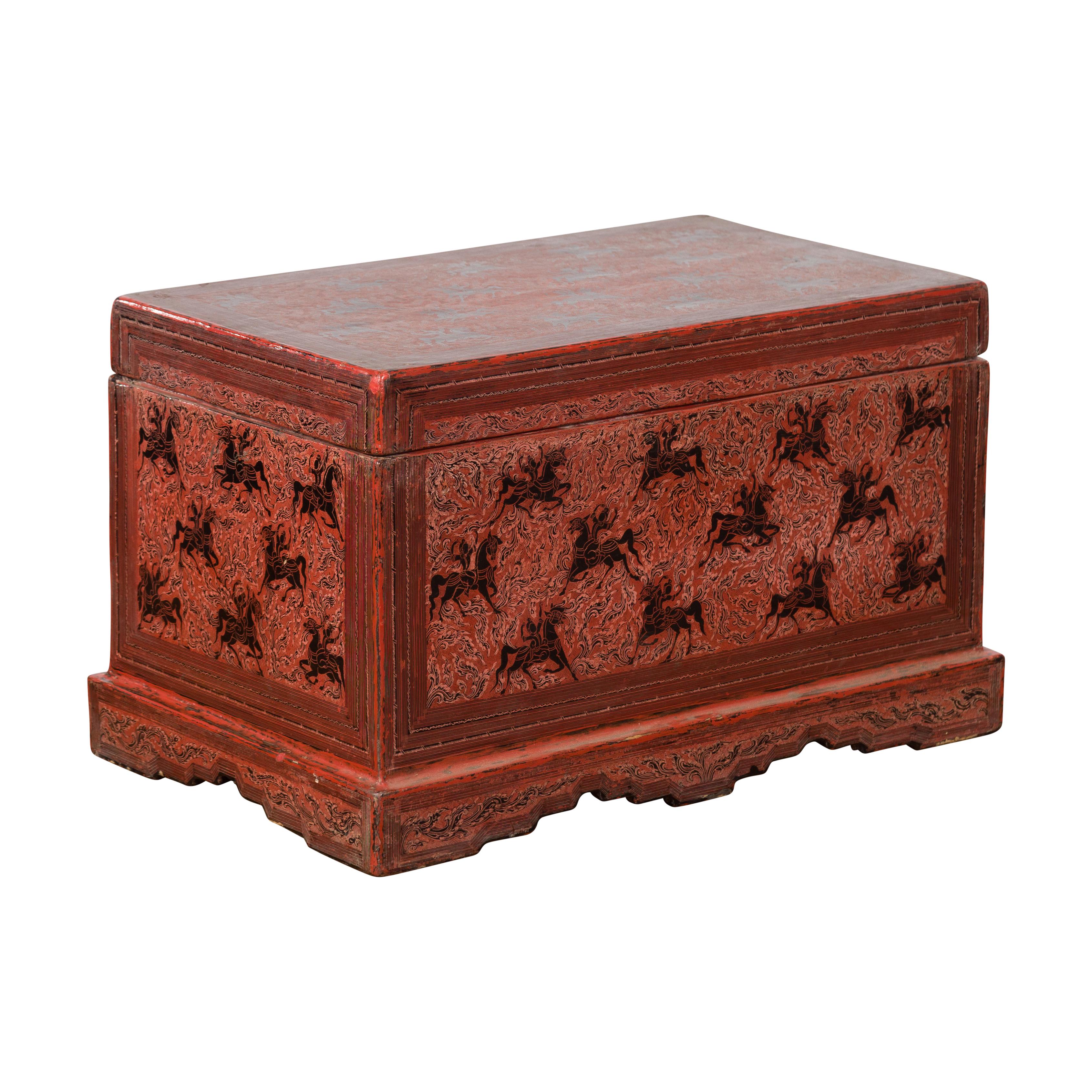 An Indonesian Palembang trunk from the late 19th, early 20th century, with hand-painted décor. Created in Indonesia during the Turn of the Century, this Palembang trunk attracts our attention with its red ground beautifully adorned with a perfectly