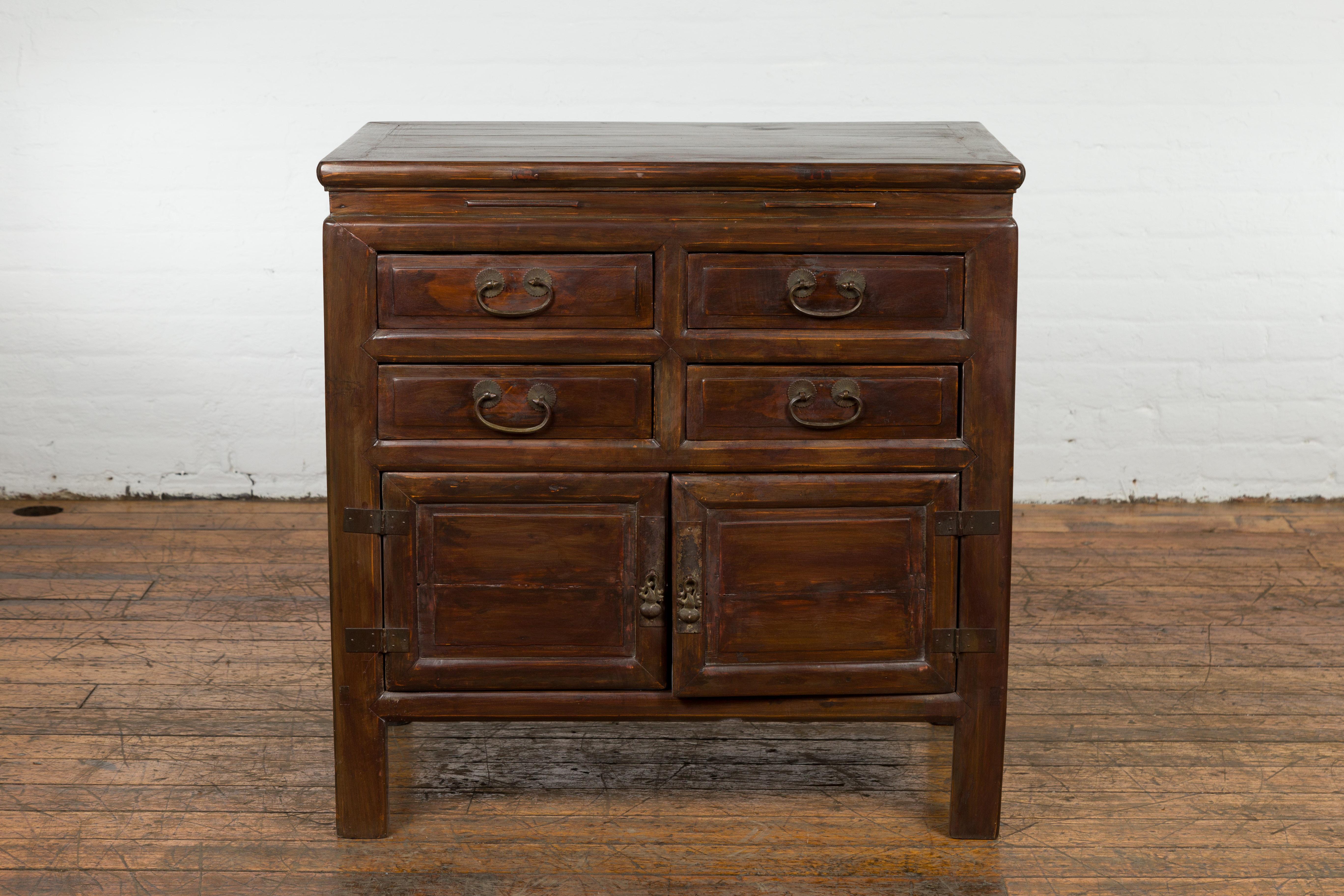 A Chinese late Qing Dynasty period bedside cabinet from the early 20th century with four drawers and double doors. This late Qing Dynasty period bedside cabinet exudes charm from the early 20th century. Crafted with precision, this Chinese piece
