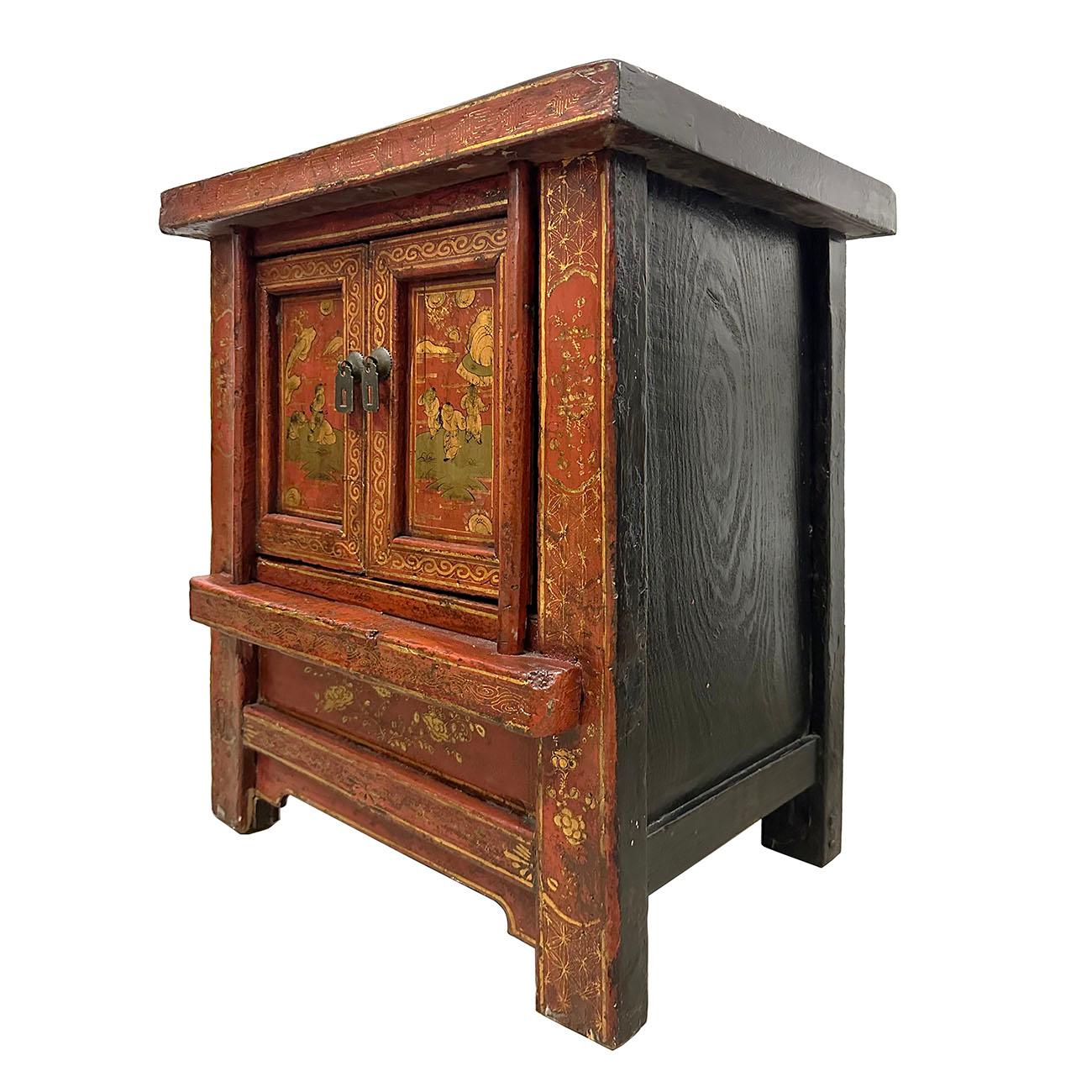 A Chinese late Qing Dynasty period painted wooden bedside cabinet from early 20th century, with two doors, carved apron and folks art painting. Created in China during the late Qing Dynasty in the early 20th century, this wooden bedside cabinet