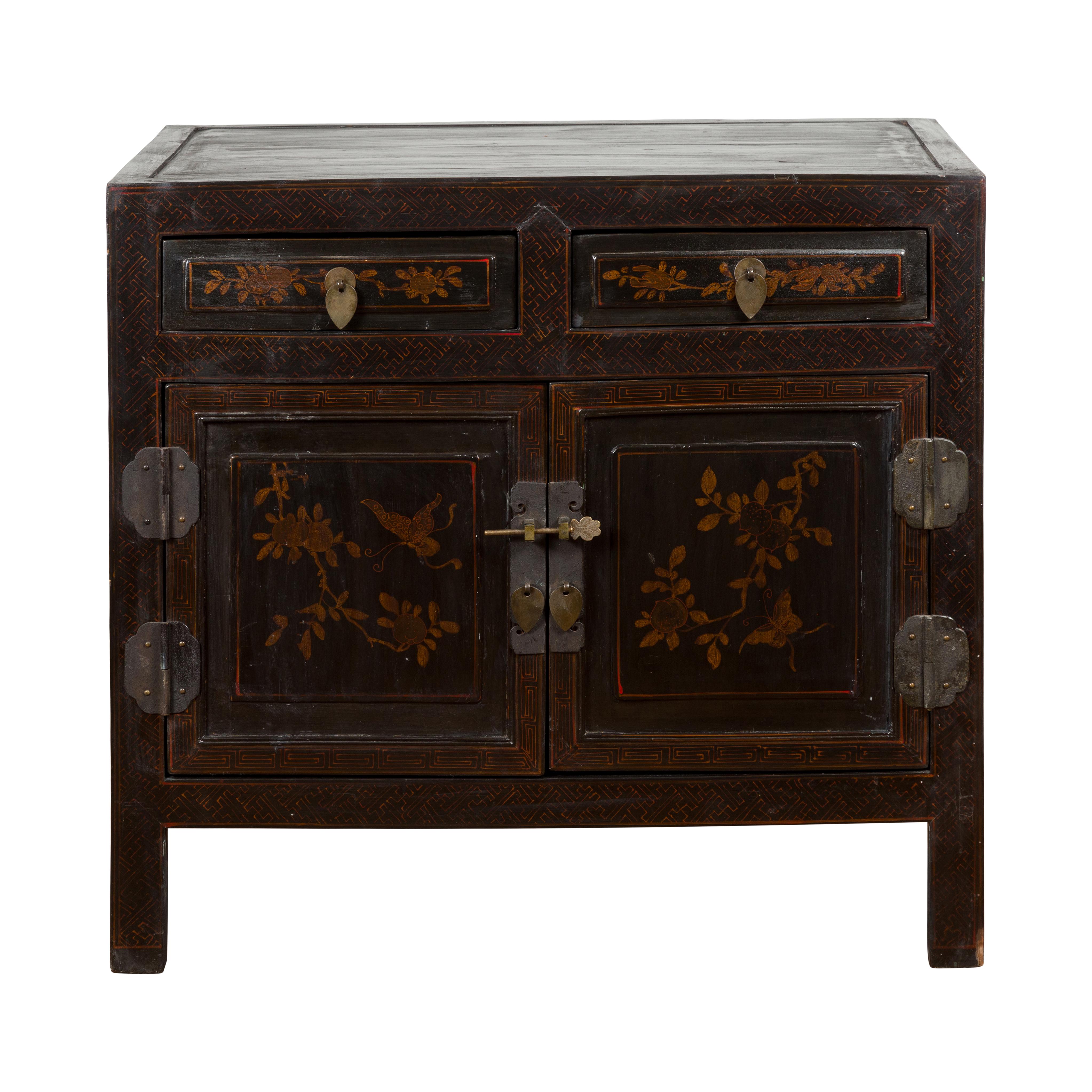 A Chinese late Qing Dynasty period dark brown lacquered cabinet from the early 20th century with floral motifs, patinated brass hardware and etched butterfly key. Discover the captivating beauty of this antique Chinese dark brown lacquered cabinet