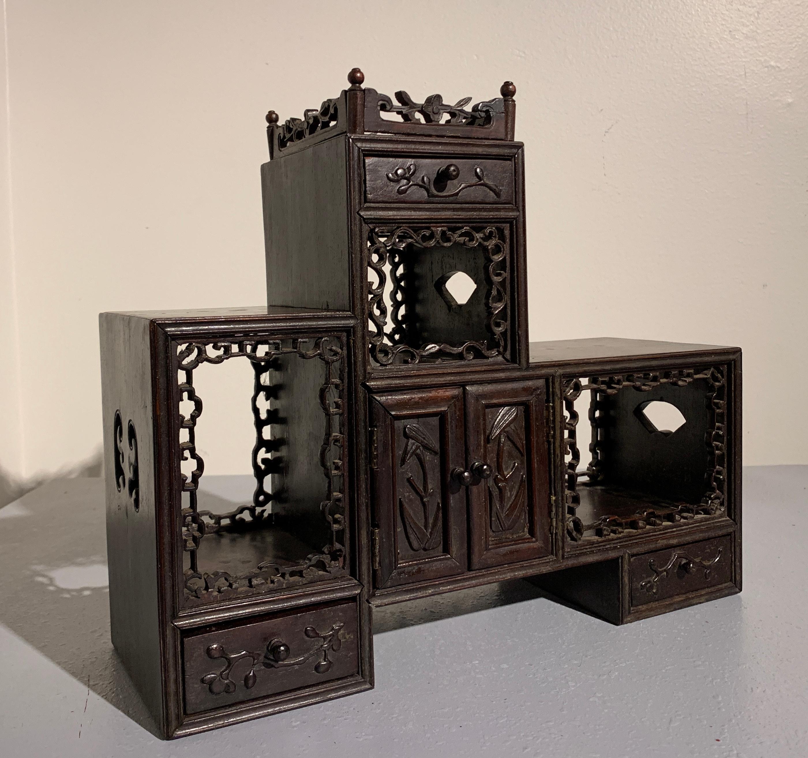 A charming Chinese miniature hardwood doubaoge, Qing Dynasty, late 19th century. 

The duobaoge is a multi-tiered display cabinet used to hold objects of art and curios, often to highlight discreet collections. An element of both the scholar