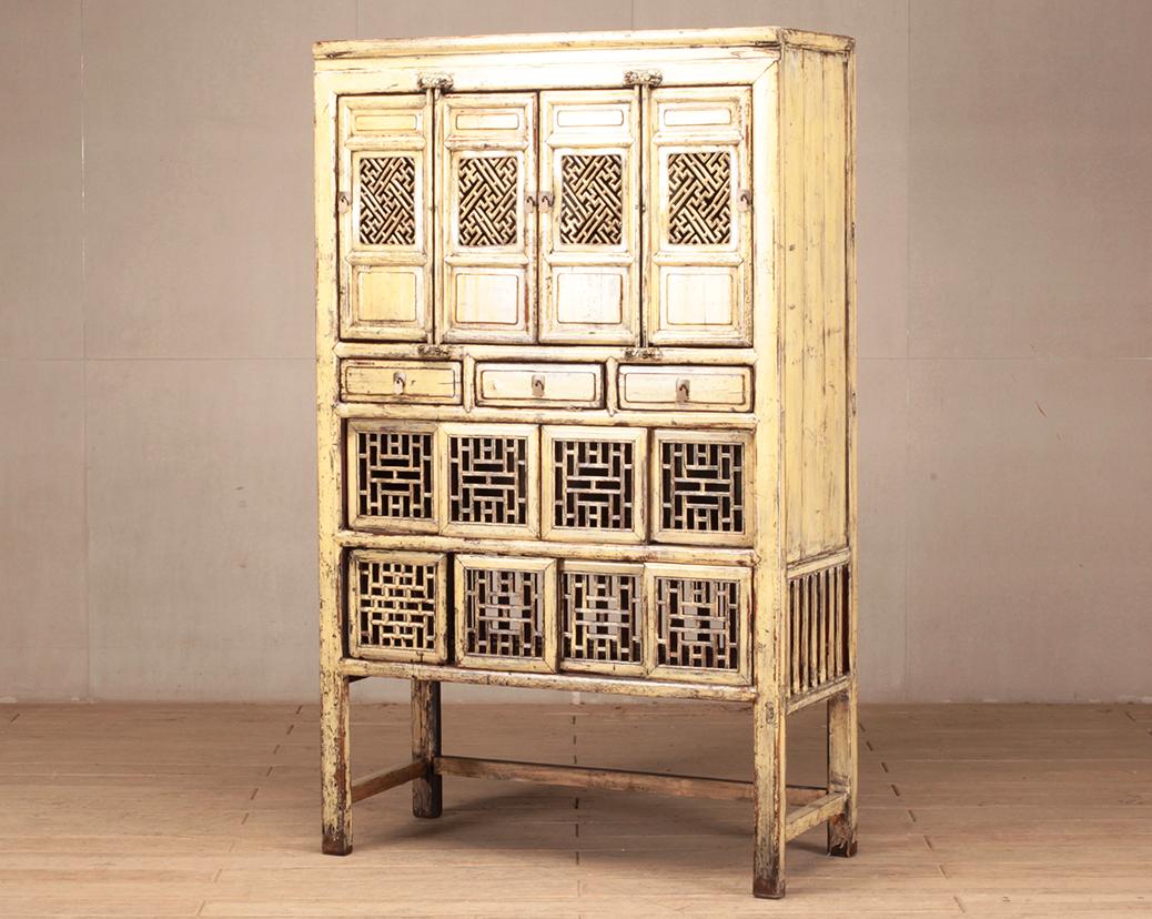 Chinese furniture is known for its practicality, beauty, and sturdy construction. This storage cabinet features lattice doors and a finish that has aged to a beautiful patina. Though this is a “softwood” piece; made from pine wood, it has the