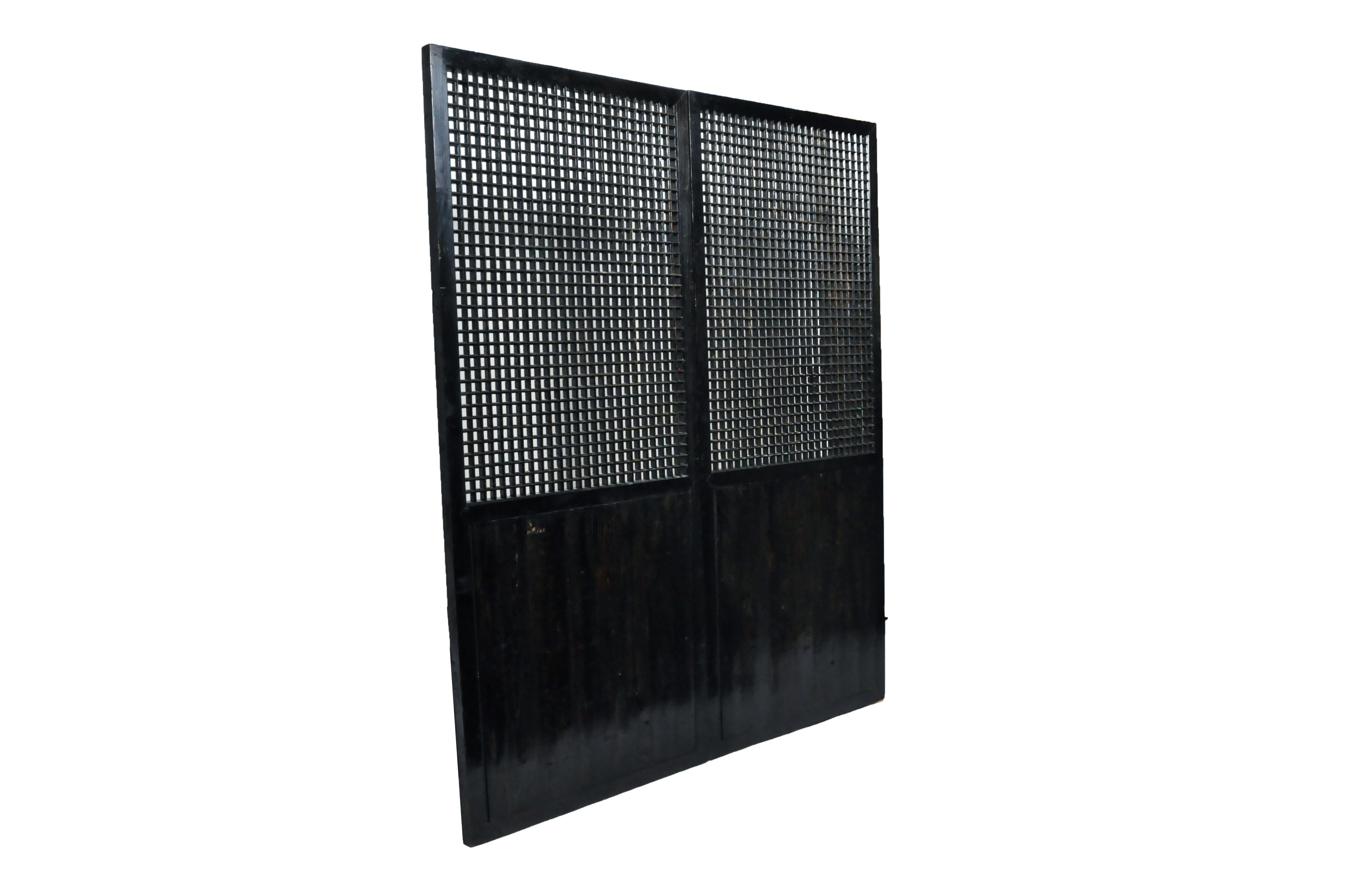 This elegant wall lattice once fit inside tracks in the floor and ceiling for easy removal. Though visually simple, close inspection reveals the lattice to be finely beveled with a sharply pointed primary side and a flat back side.  Though lattice