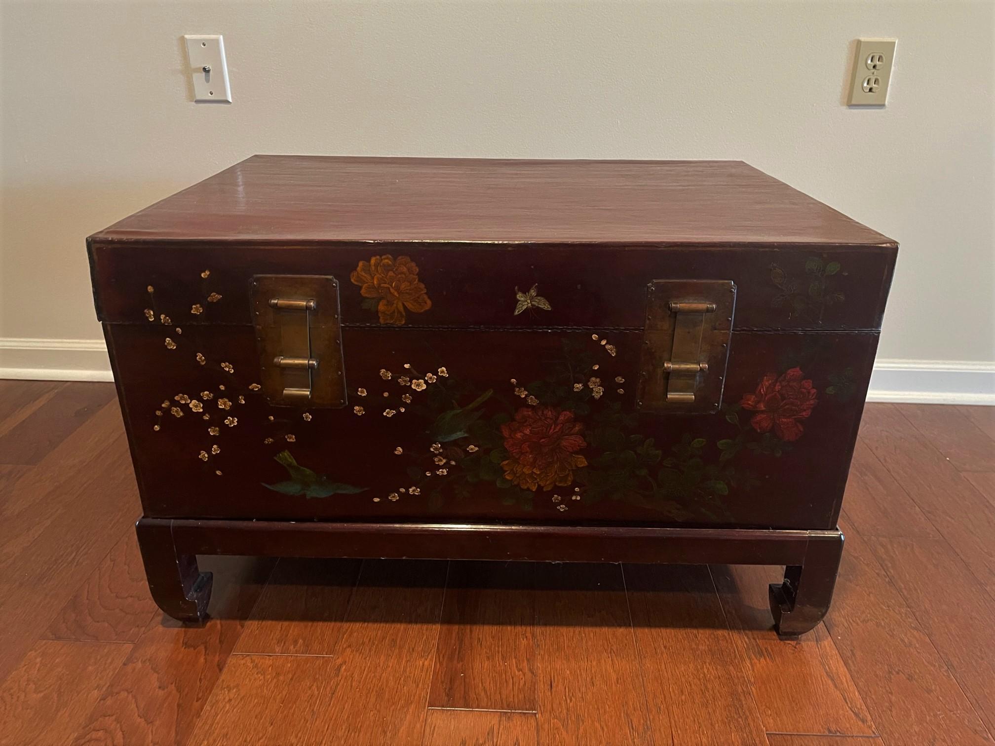 Chinese leather trunk, 18th Century. Colored floral motif painted on sides/top; lined with writing on paper. Measures: 32.25