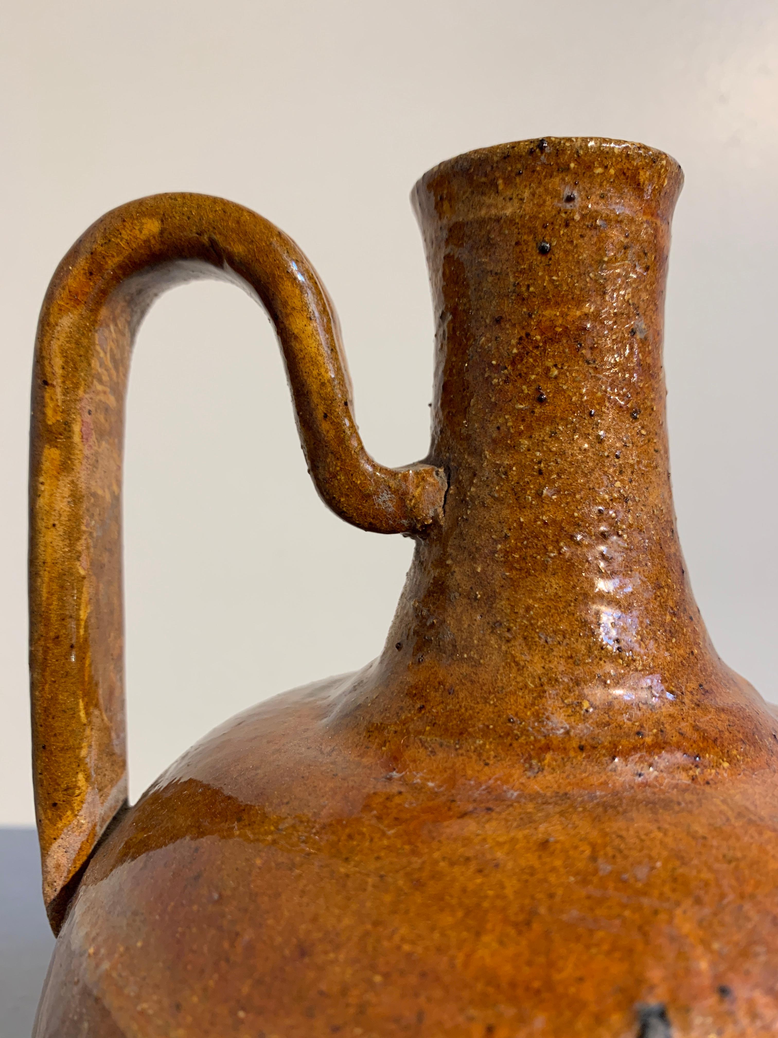 Chinese Liao Dynasty Amber Glazed Stoneware Strap Handle Ewer, 11th Century In Good Condition For Sale In Austin, TX