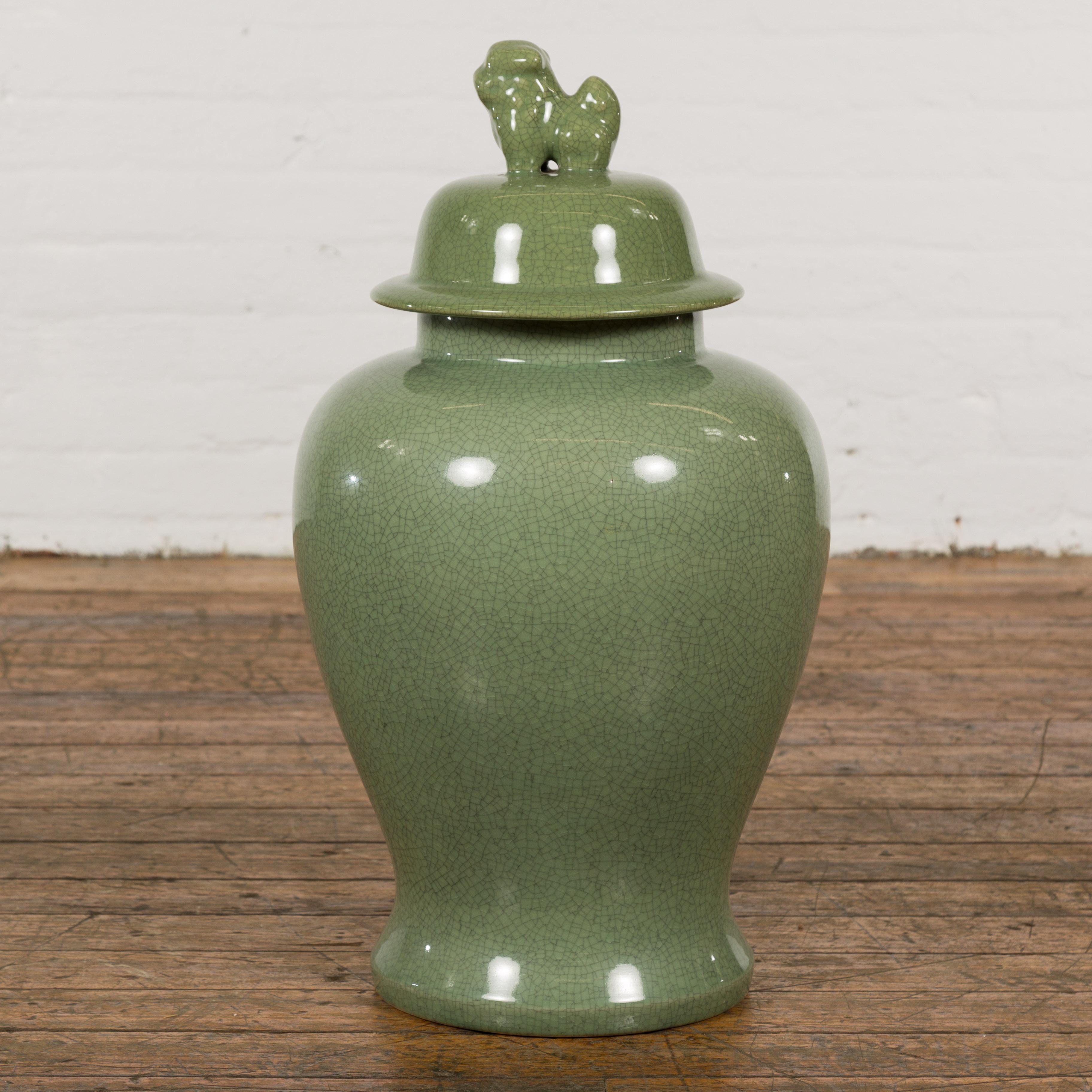 Chinese Lidded Altar Vase with Green Celadon Glaze and Guardian Lion Motif In Good Condition For Sale In Yonkers, NY