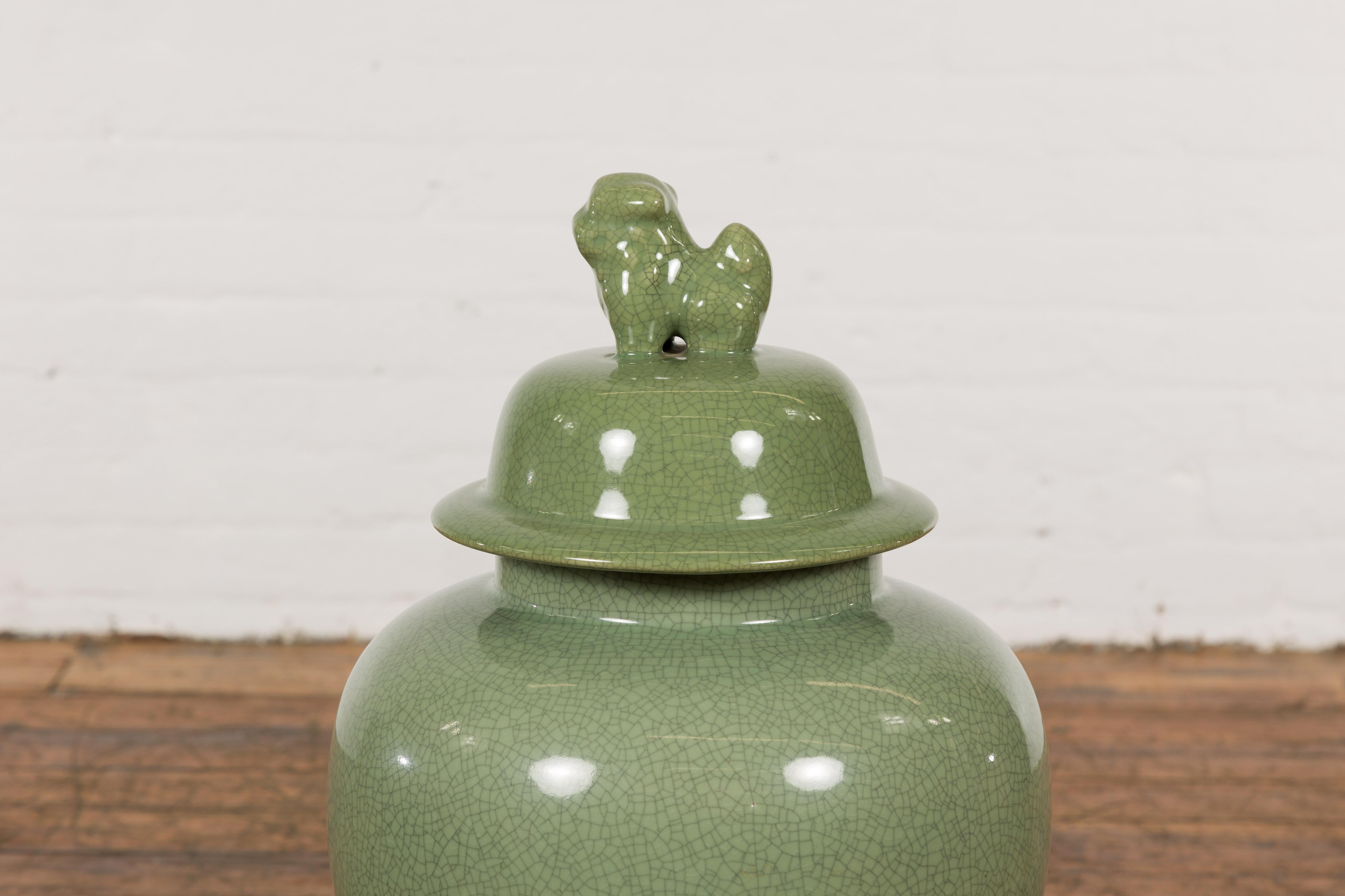 20th Century Chinese Lidded Altar Vase with Green Celadon Glaze and Guardian Lion Motif For Sale