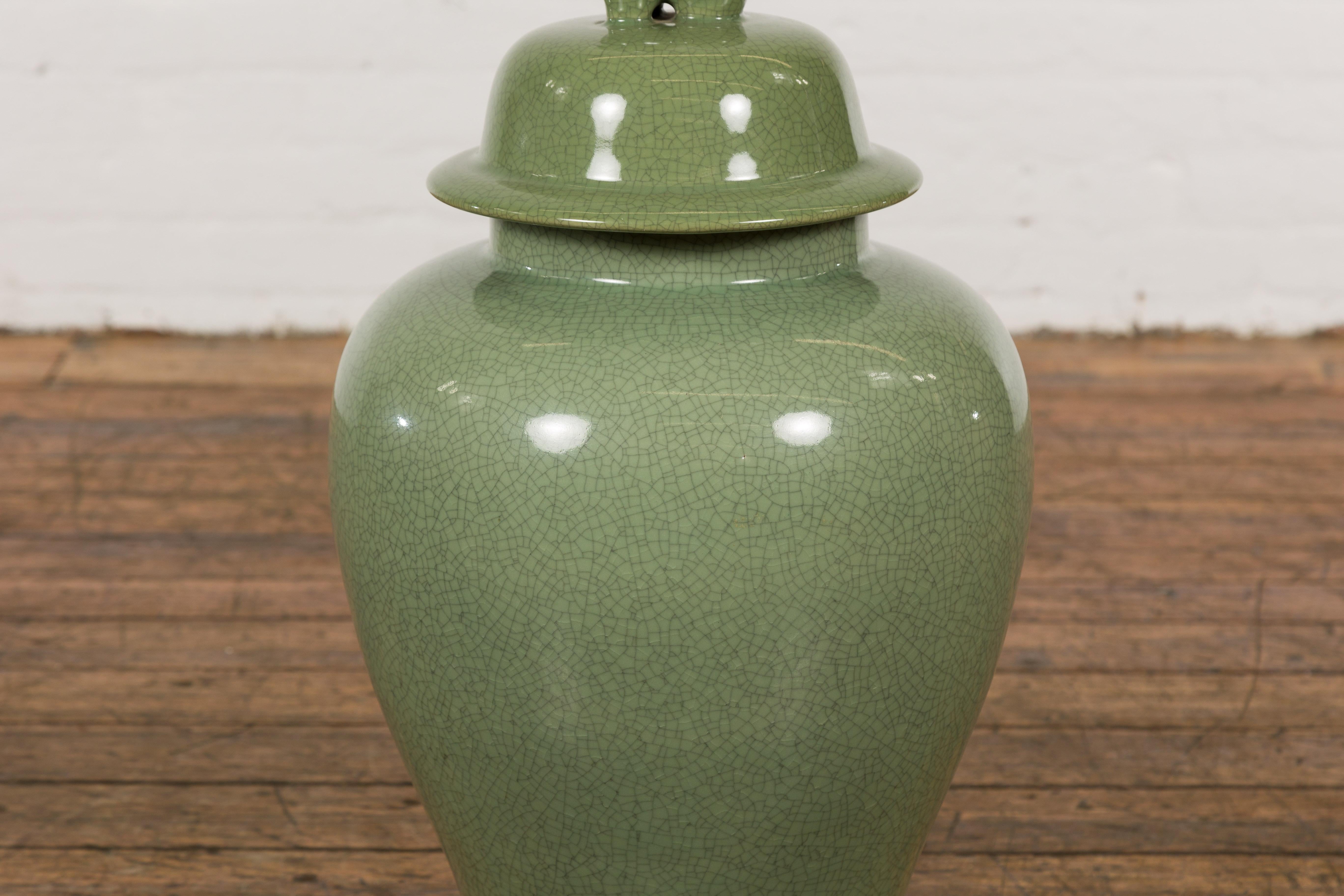 Ceramic Chinese Lidded Altar Vase with Green Celadon Glaze and Guardian Lion Motif For Sale